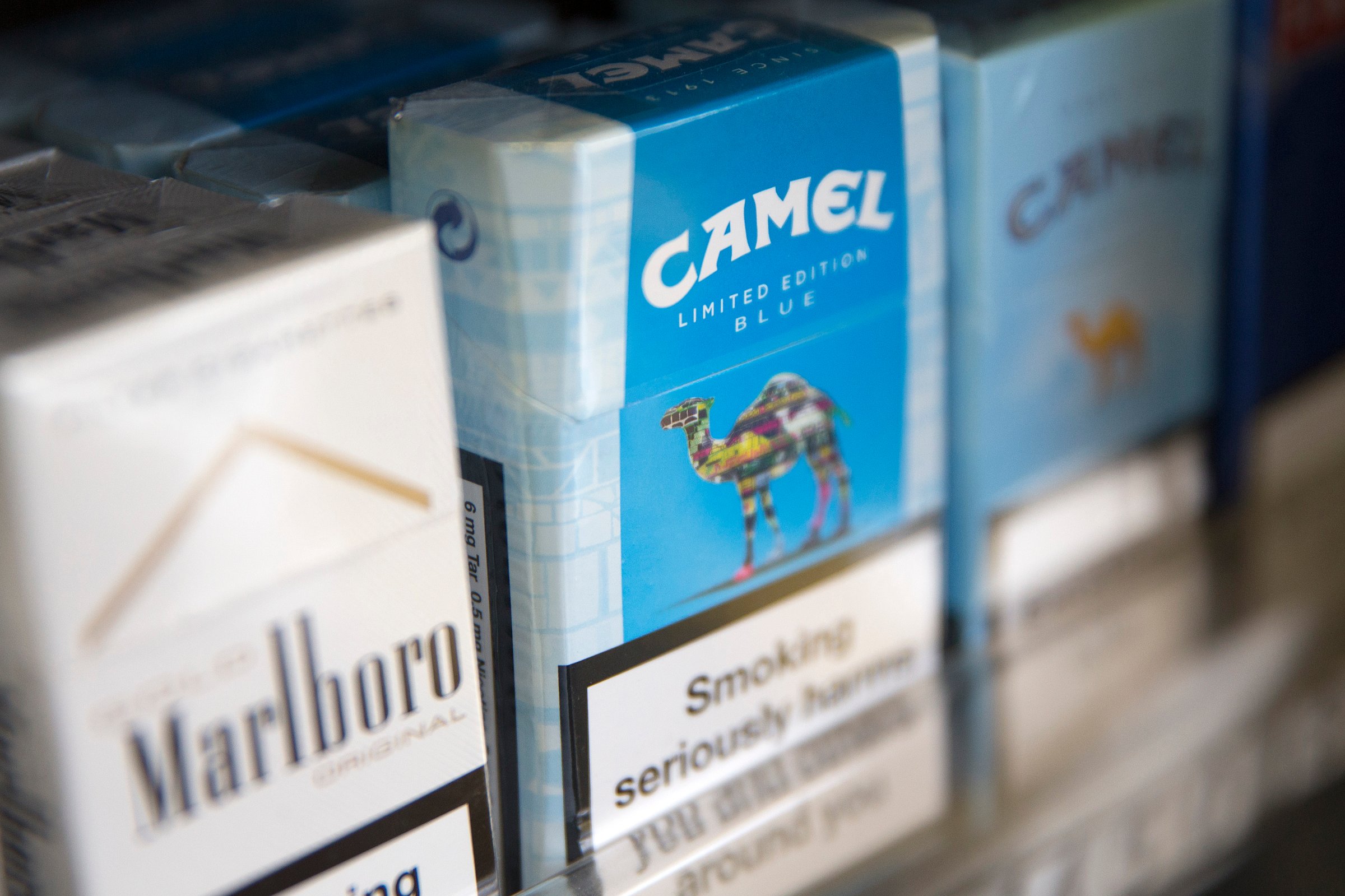 Packs of Camel cigarettes, manufactured by Reynolds American Inc., in a display rack in London on July 11, 2014.