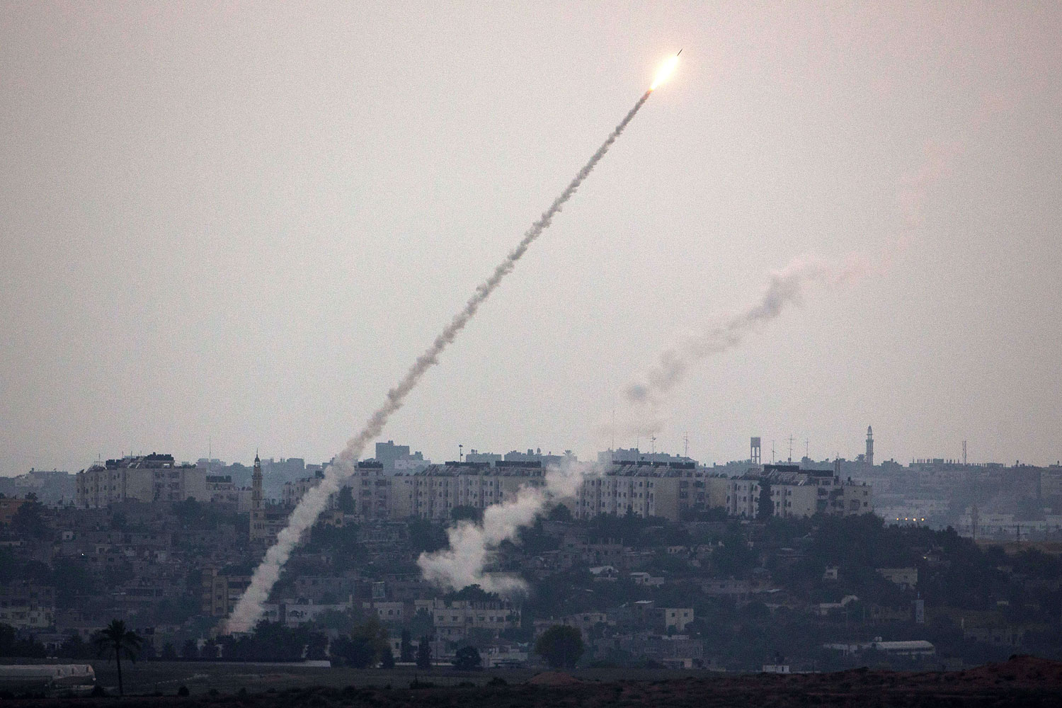 A picture taken from the southern Israeli Gaza border shows a militant rocket being launched from the Gaza strip into Israel, on July 11, 2014. (Menahem Kahana—AFP/Getty Images)