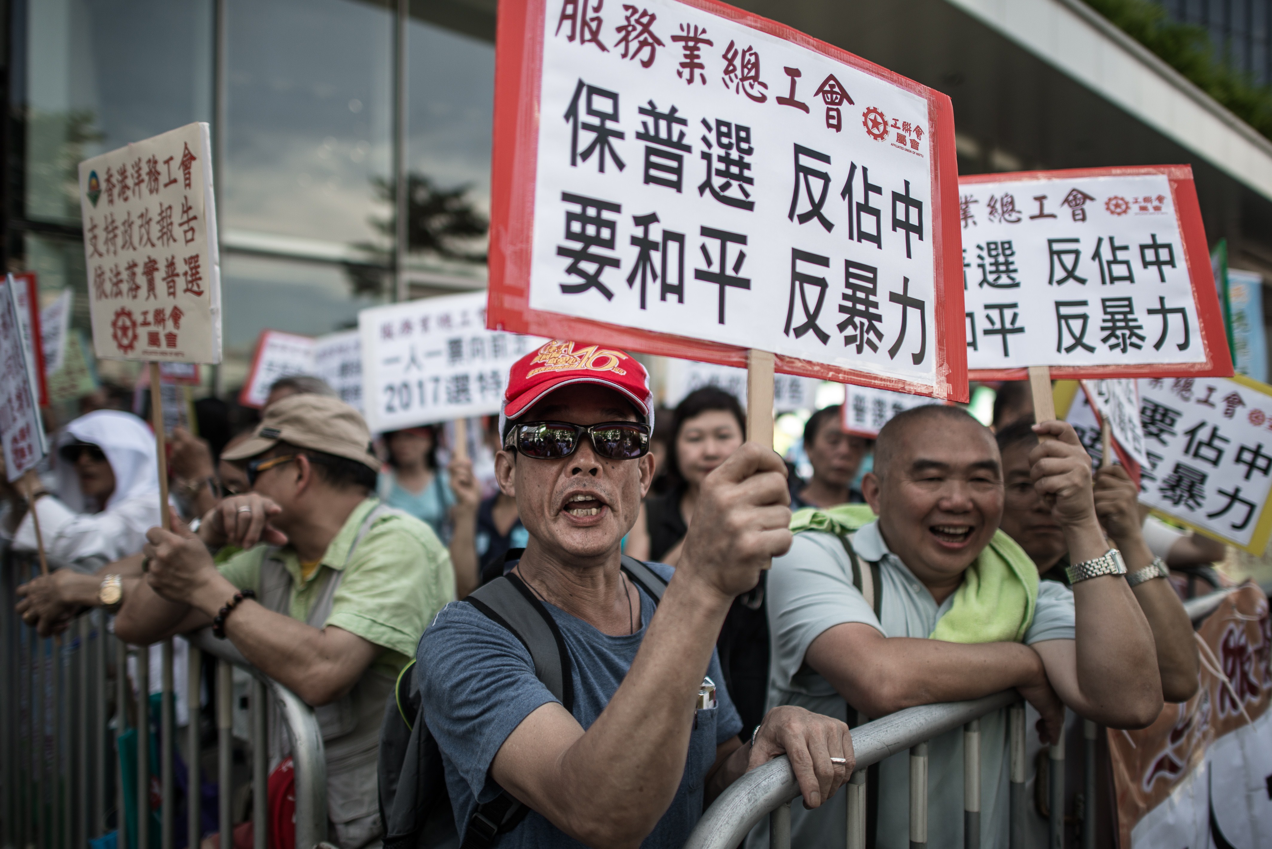 Demonstrators rally against the Occupy Central movement to show their support to the Hong Kong government in Hong Kong on July 15, 2014.  Hong Kong's government  has unveiled its vision for electoral reform as public pressure for democracy grows and activists pledge to take over the city if their demands are not met (Philippe Lopez—AFP/Getty Images)