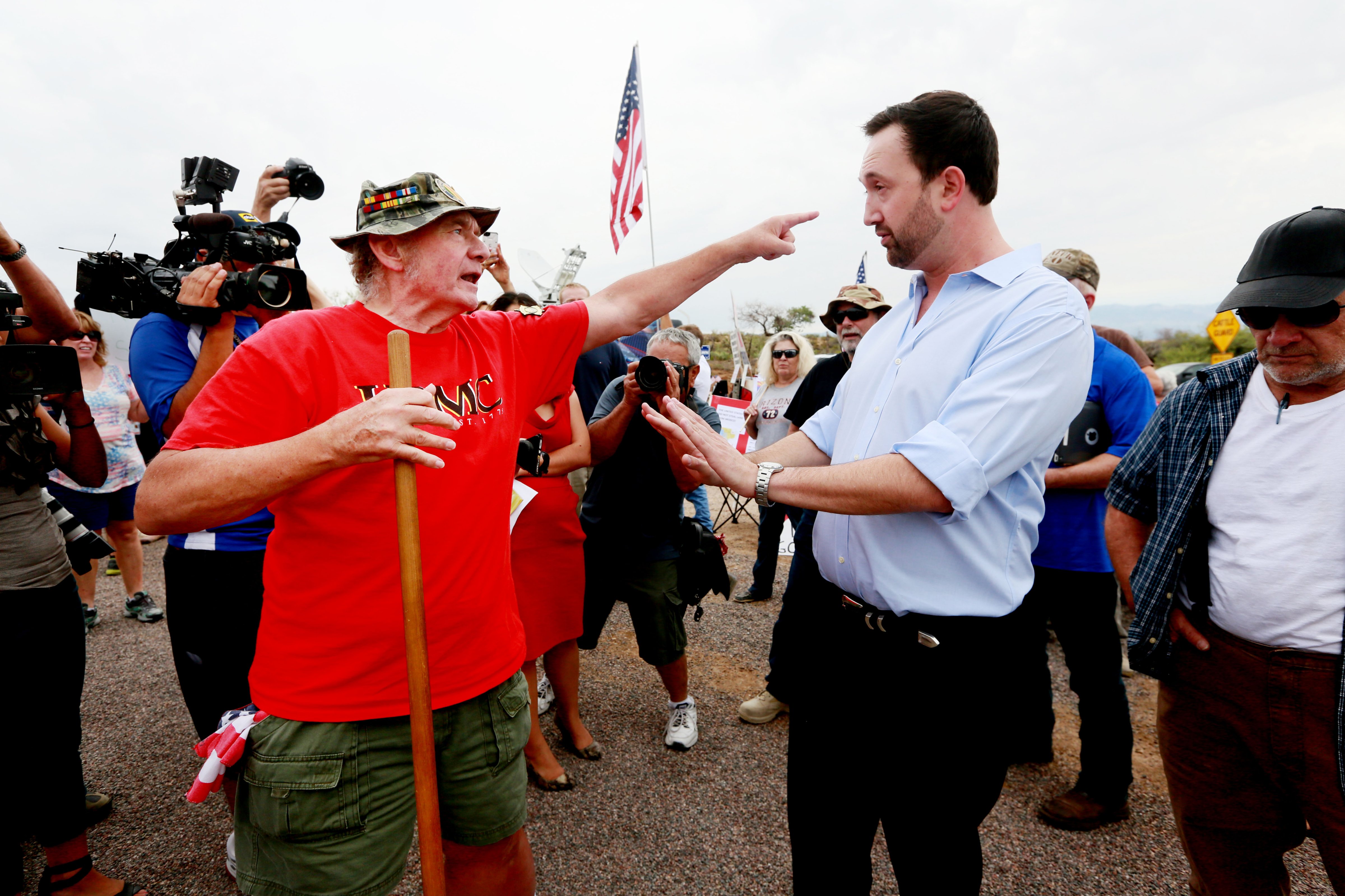 Adam Kwasman, a Tea Party patriot running for congress (R), has a heated discussion with an anti-immigration activist during a protest along Mt. Lemmon Road in anticipation of buses carrying  illegal immigrants on July 15, 2014 in Oracle, Arizona. (Sandy Huffaker—Getty Images)