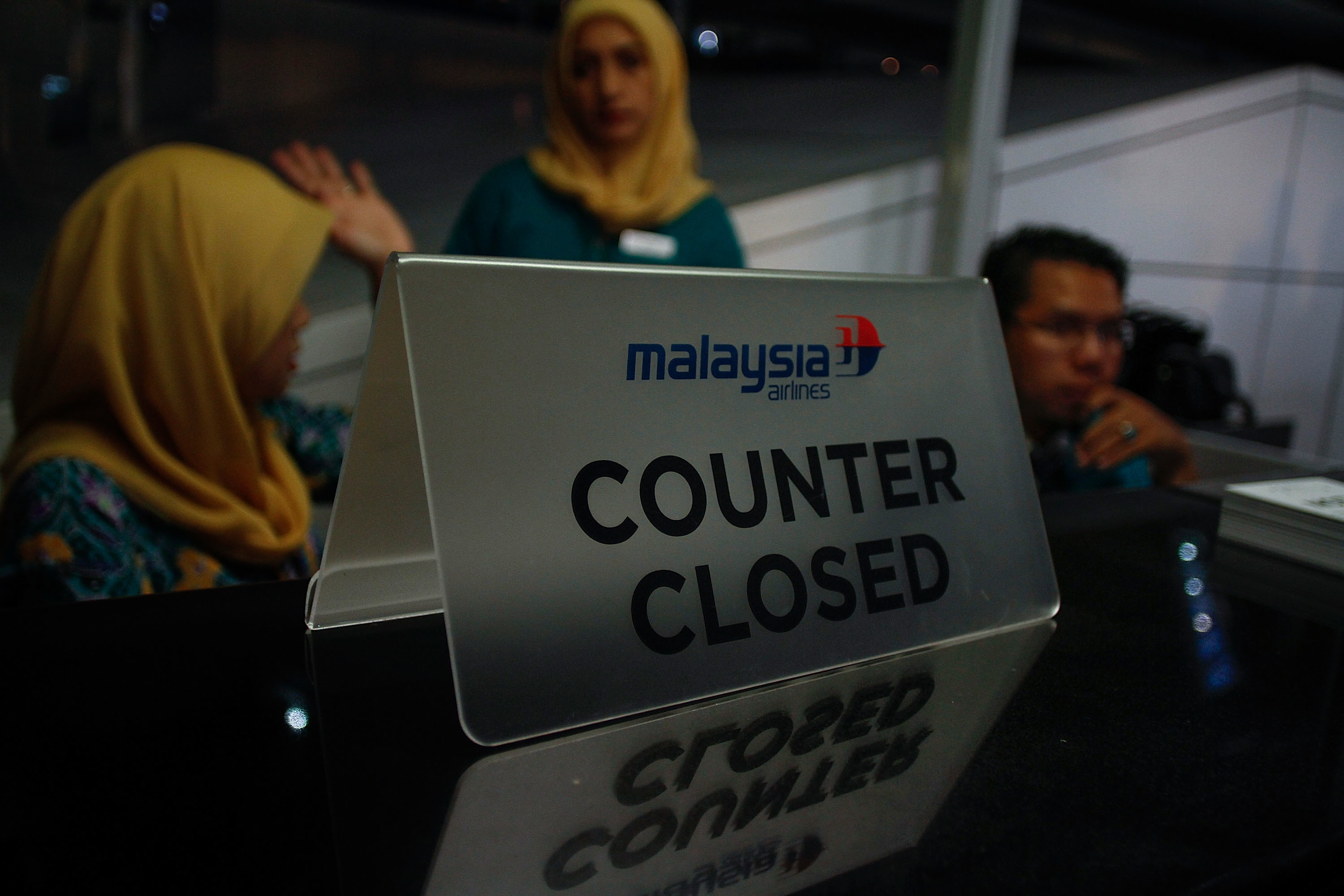 Malaysia Airlines crew closed the counter at Kuala Lumpur International Airport Terminal 1 on July 18, 2014 in Putrajaya, Malaysia. (Rahman Roslan—Getty Images)