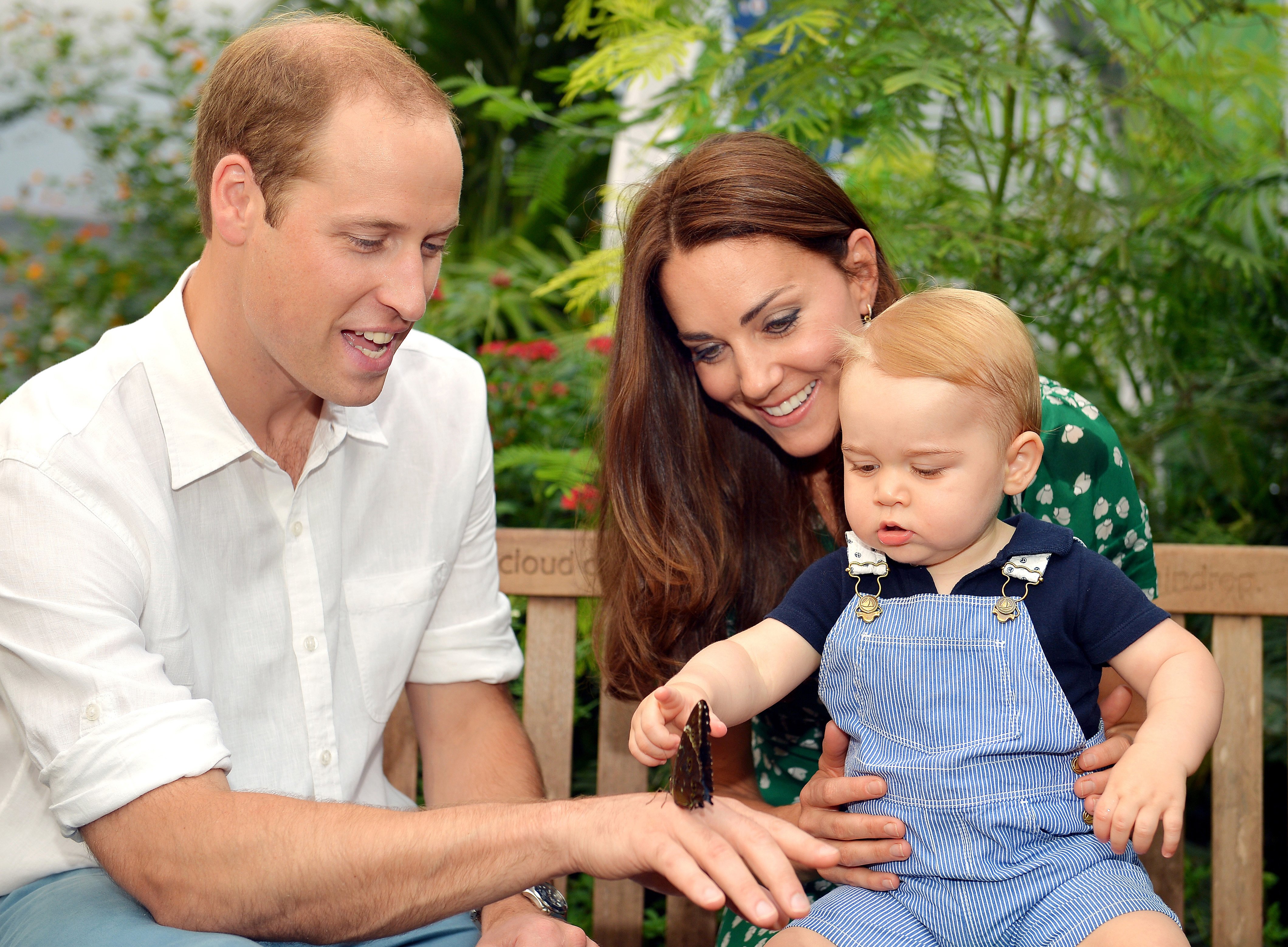 Catherine, Duchess of Cambridge holds Prince George as he points to a butterfly on Prince William, Duke of Cambridge's hand as they visit the Sensational Butterflies exhibition at the Natural History Museum on July 2, 2014 in London, England. (John Stillwell—WPA/Getty Images)