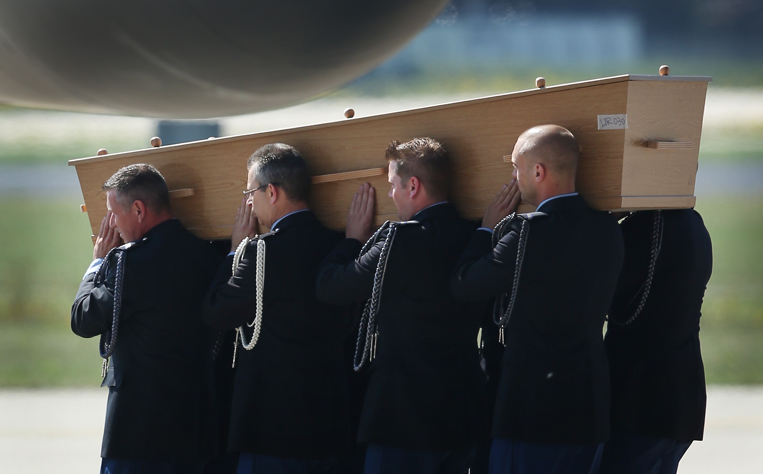 A numbered coffin carried by Dutch military personnel contains an unidentified body from the crash of MH17 on July 23, 2014 at Eindhoven airport, Netherlands. (Peter Macdiarmid—Getty Images)