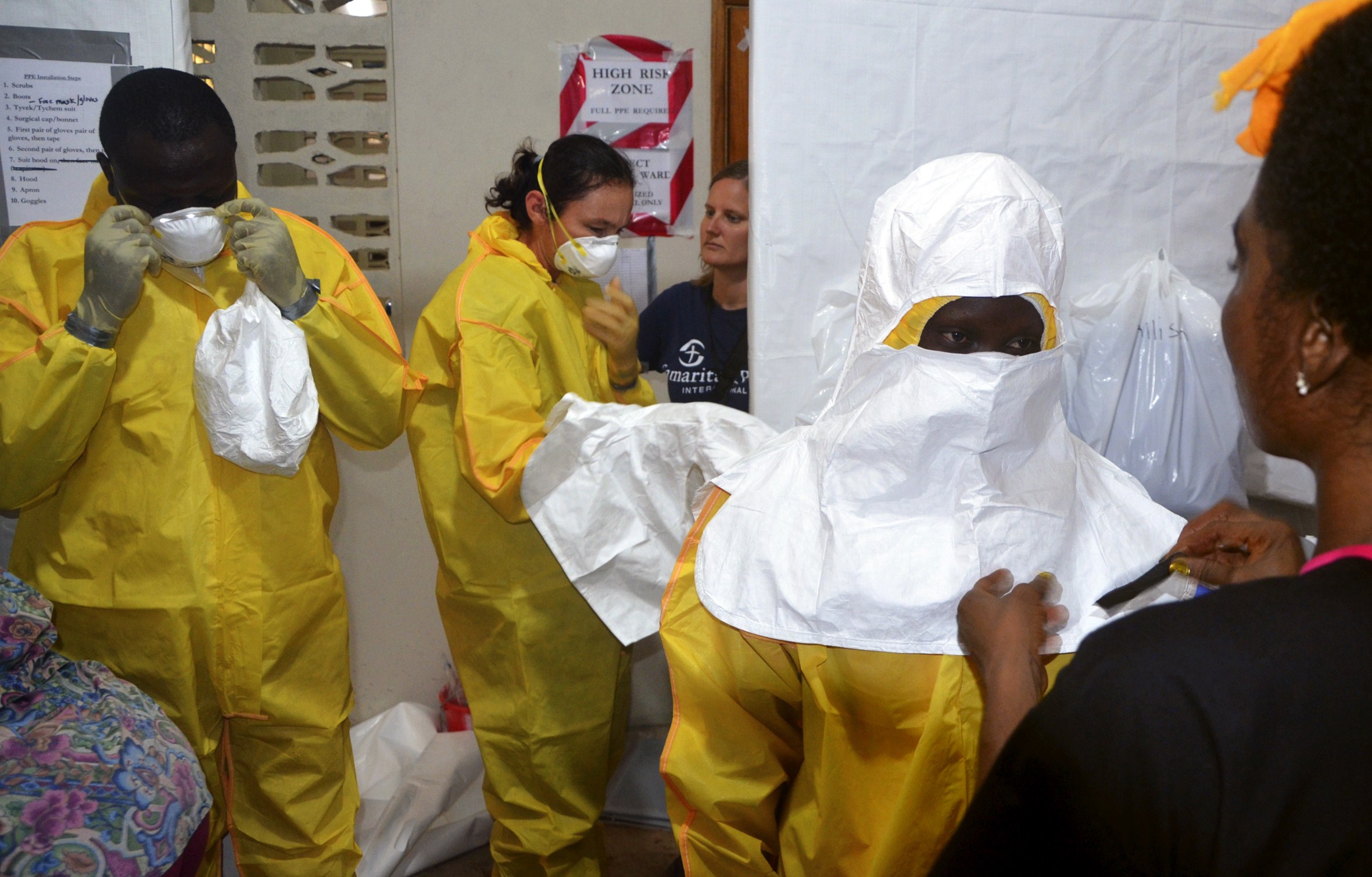 Staff of the Christian charity Samaritan's Purse putting on protective gear in the ELWA Hospital in Monrovia, Liberia, on July 24, 2014 (Zoom Dosso—AFP/Getty Images)