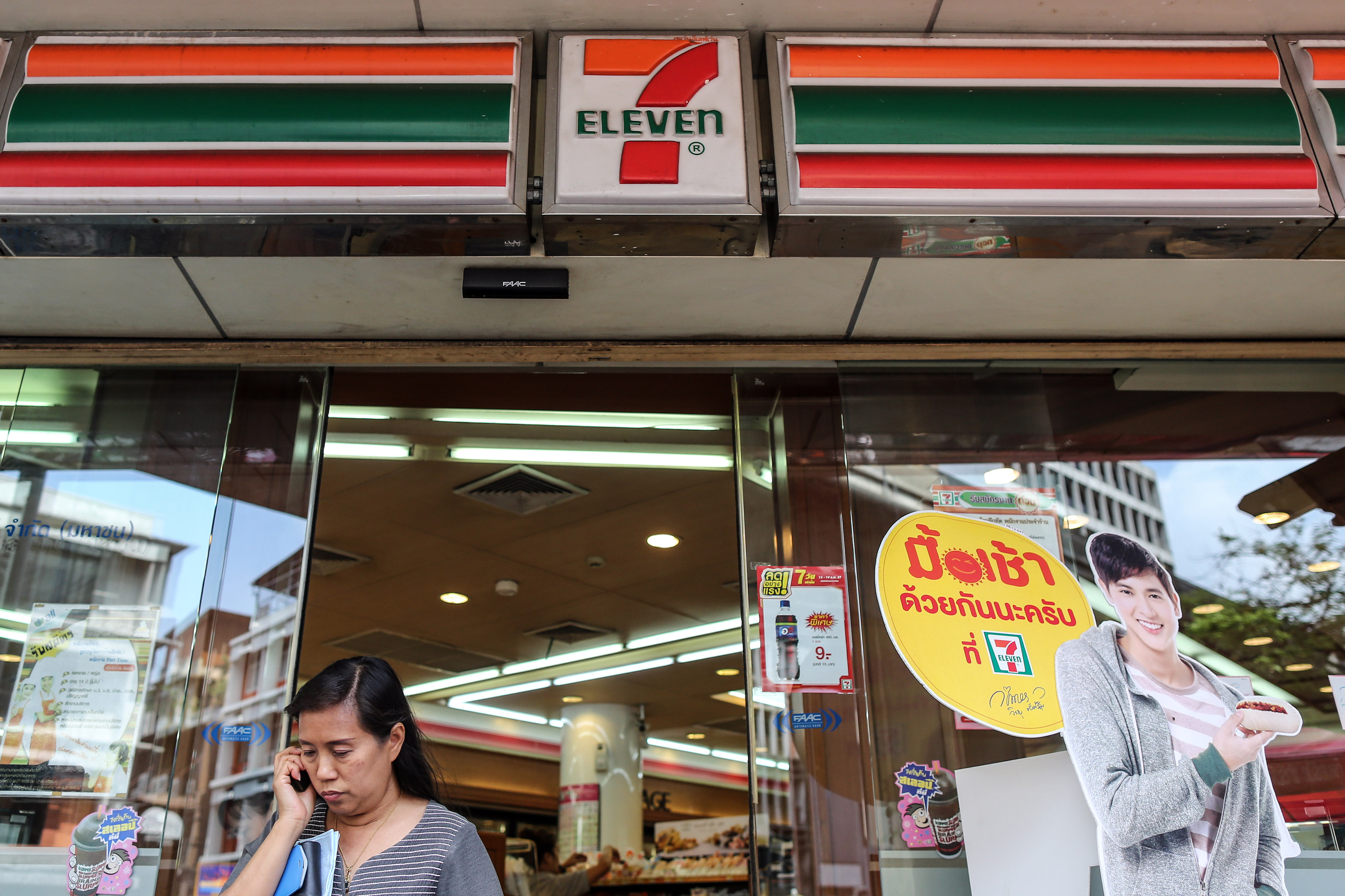 A customer exits a 7-Eleven convenience store, operated by CP All Pcl, in Bangkok, Thailand, on Wednesday, Feb. 19, 2014. (Dario Pignatelli—Bloomberg/Getty Images)