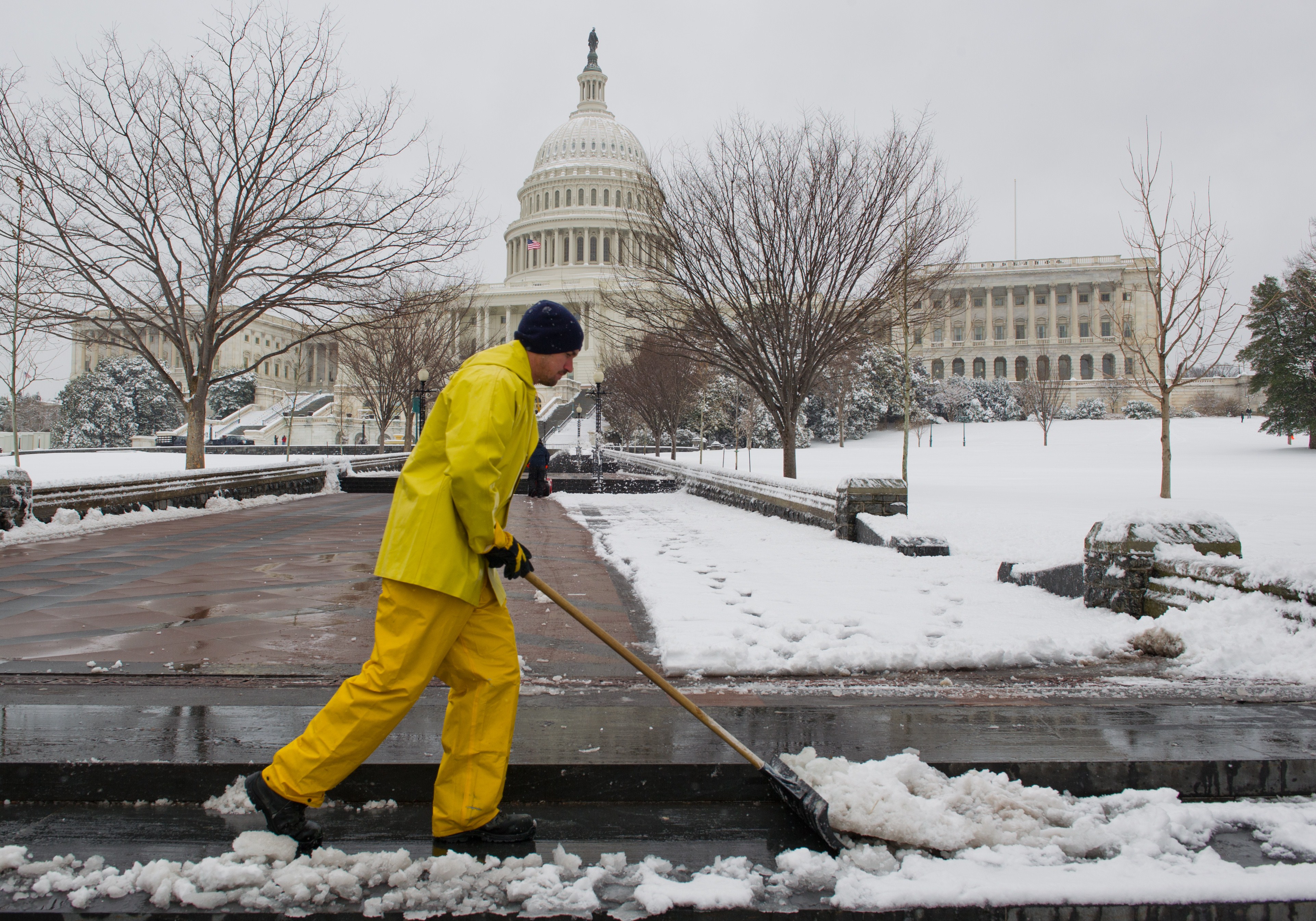 A worker shovels snow from the walkways at the U.S. Capitol in Washington, DC March 17, 2014 the morning after yet another snow storm. (Karen Bleier—AFP/Getty Images)
