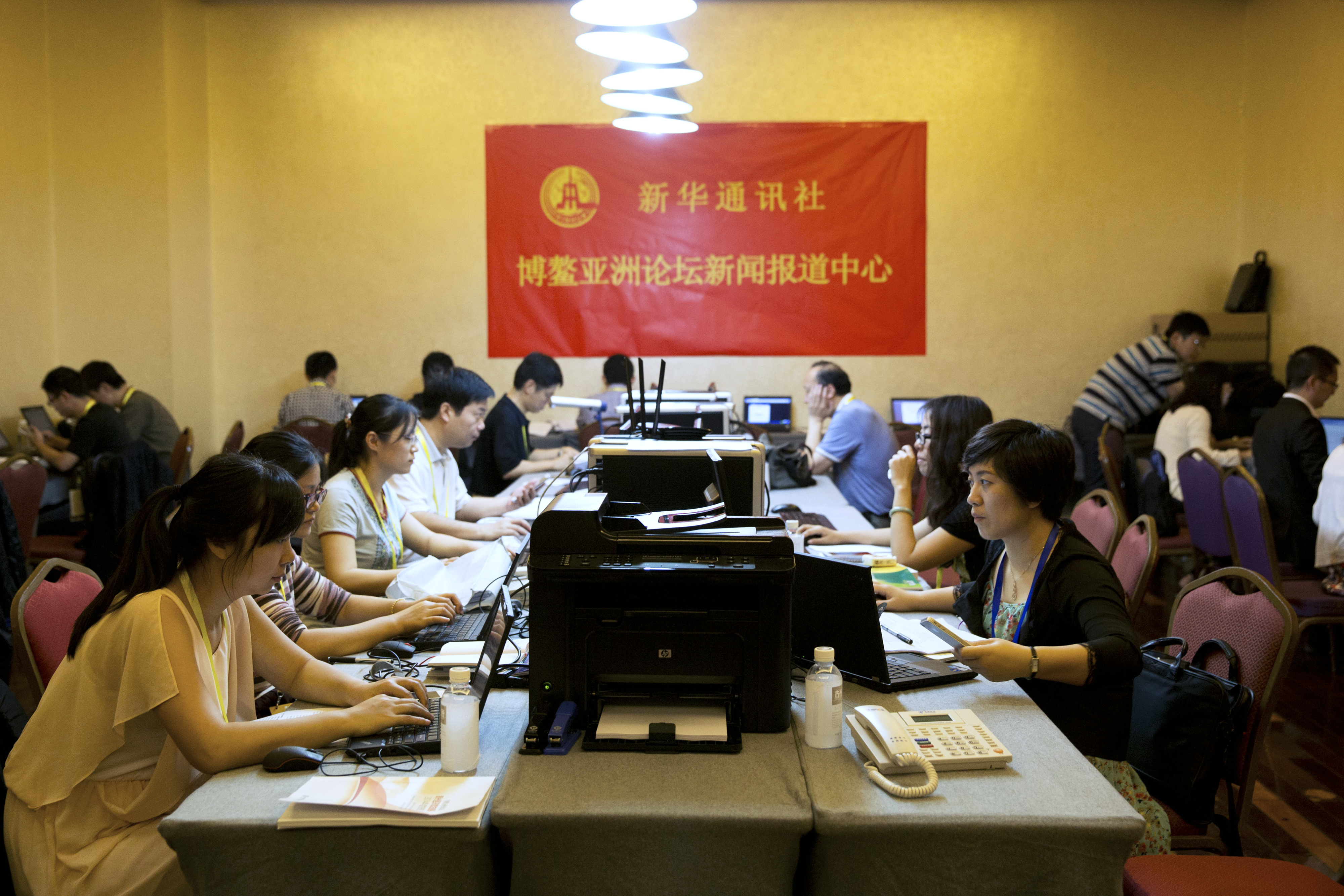 Reporters work at computers in the Xinhua press room at the Boao Forum for Asia conference in Boao, China, on April 8, 2014 (Bloomberg—Bloomberg via Getty Images)