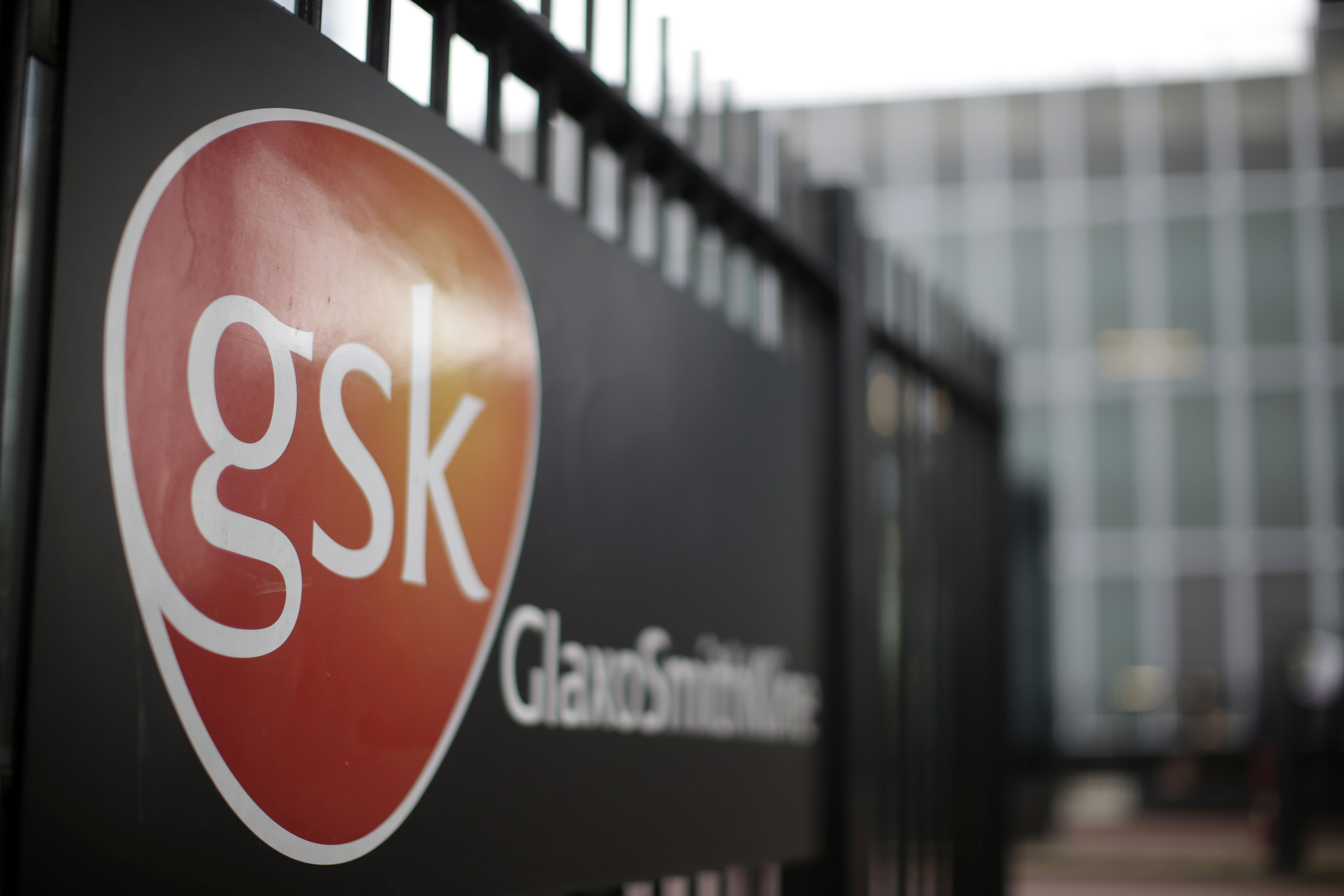 The logo of GlaxoSmithKline Plc sits on a sign outside the pharmaceutical company's headquarters in London, U.K., on Tuesday, April 22, 2014. (Matthew Lloyd/Bloomberg via Getty Images)
