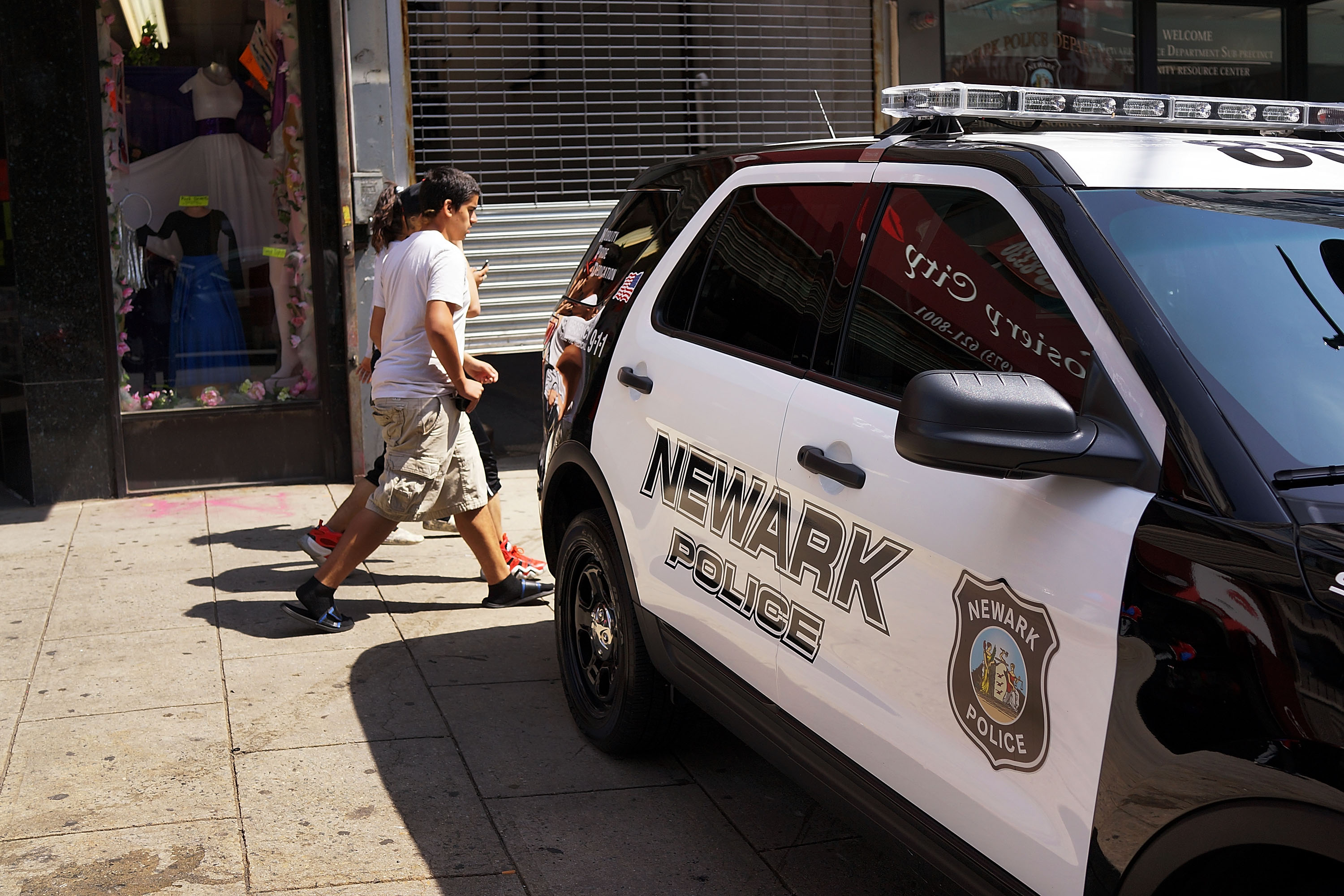 People walk by a police car in downtown on May 13, 2014 in Newark, New Jersey. (Spencer Platt&amp;mdash;Getty Images)
