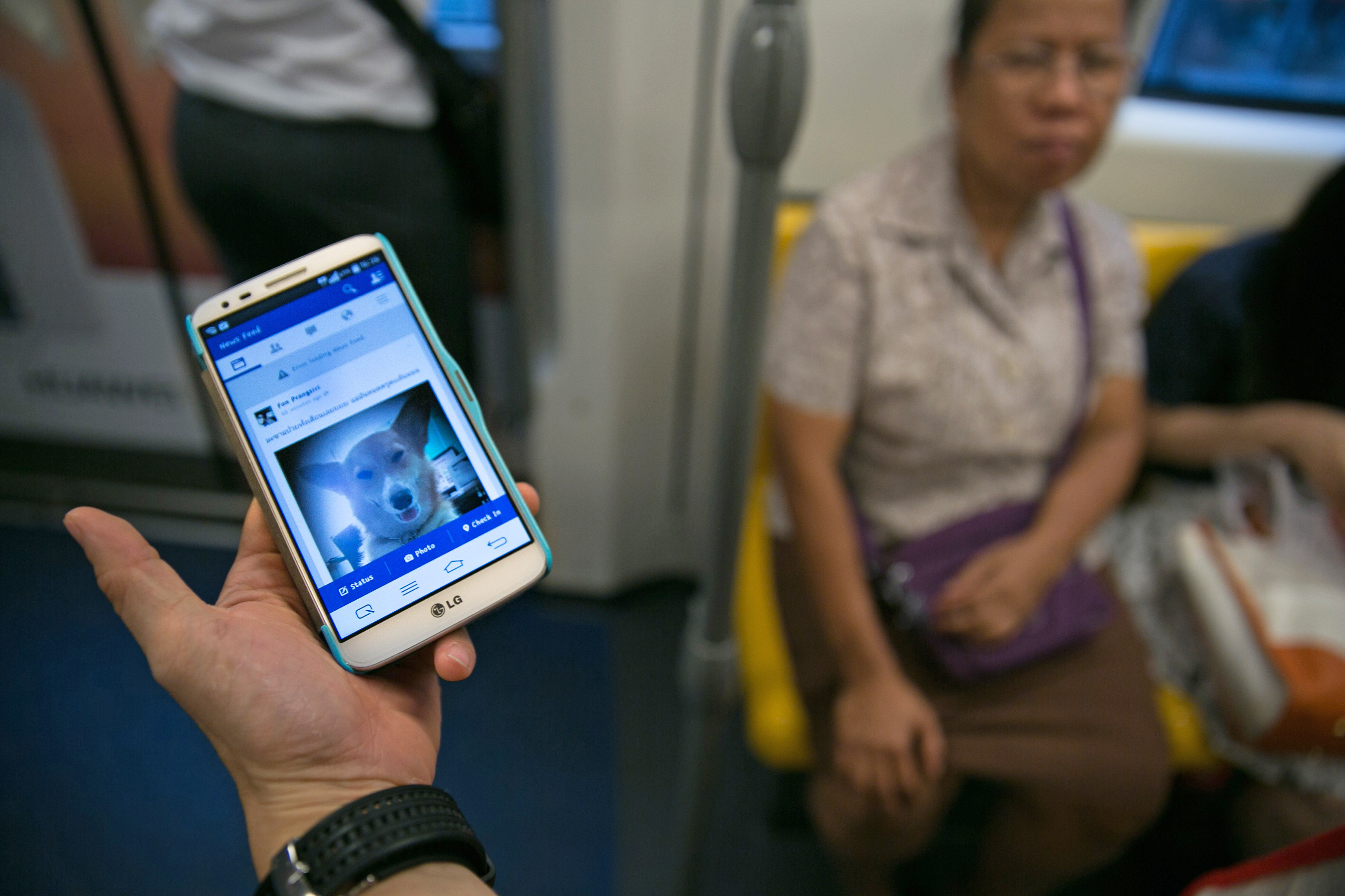 A man shows his mobile phone while riding the Bangkok sky train on May 28, 2014. A widespread Facebook outage occurred in Thailand one afternoon while the ruling military junta who staged a coup denied causing it. (Paula Bronstein—Getty Images)