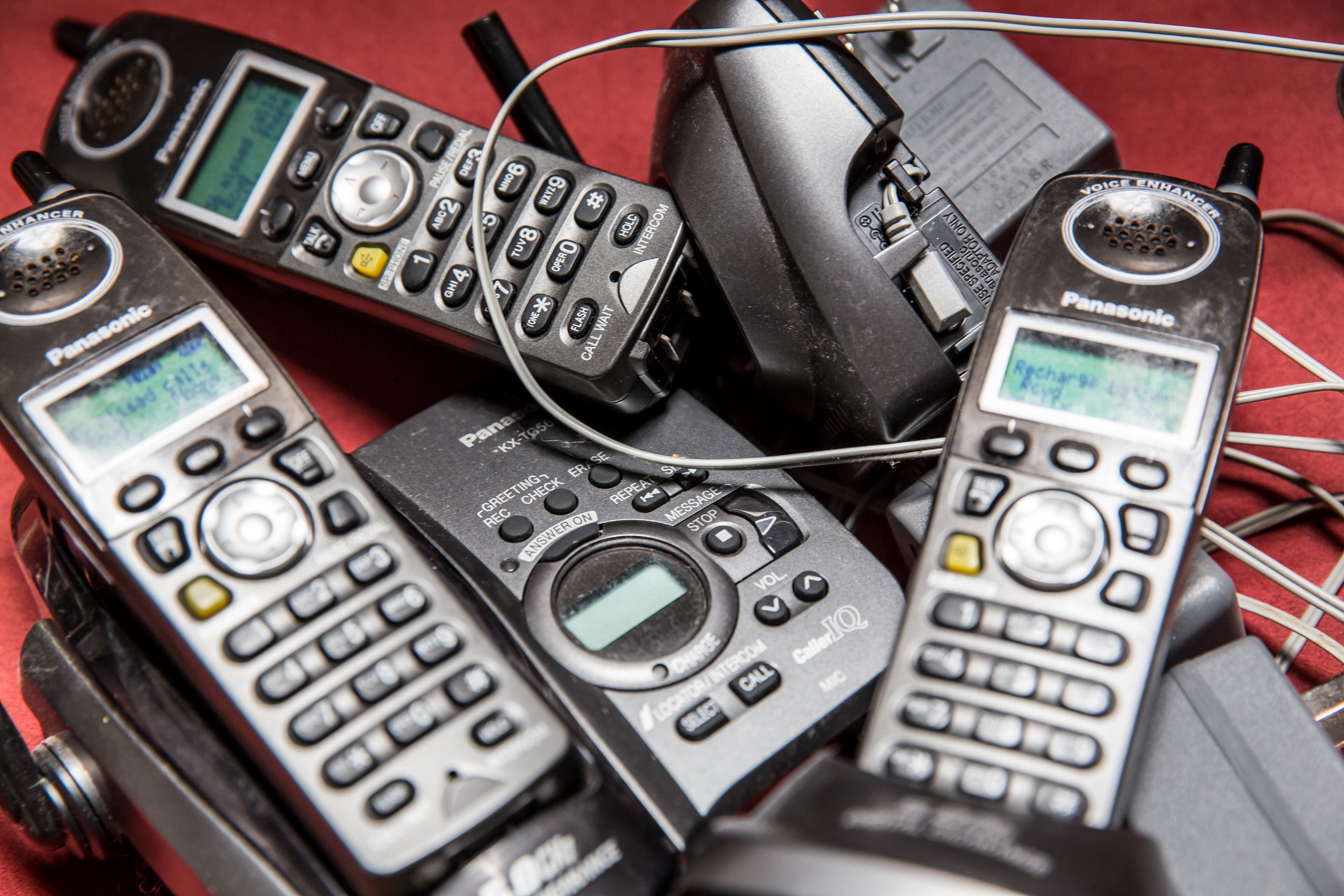 Pile of Old Cordless Style Landline Panasonic Telephones and Their Bases (Julie Thurston Photography—Moment Editorial/Getty Images)