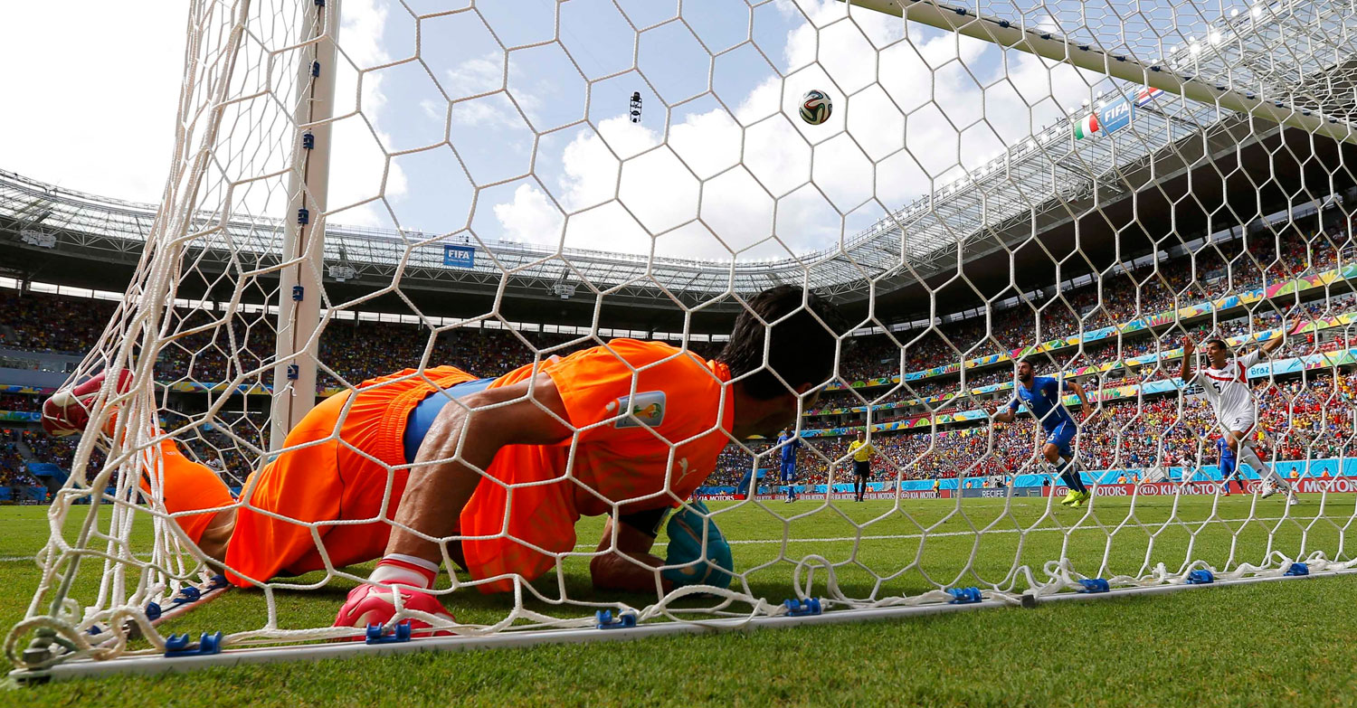 Italy's goalkeeper Gianluigi Buffon lies in the net after conceding a goal scored by Costa Rica's Bryan Ruiz during their match at the Pernambuco arena in Recife, Brazil on June 20, 2014.
