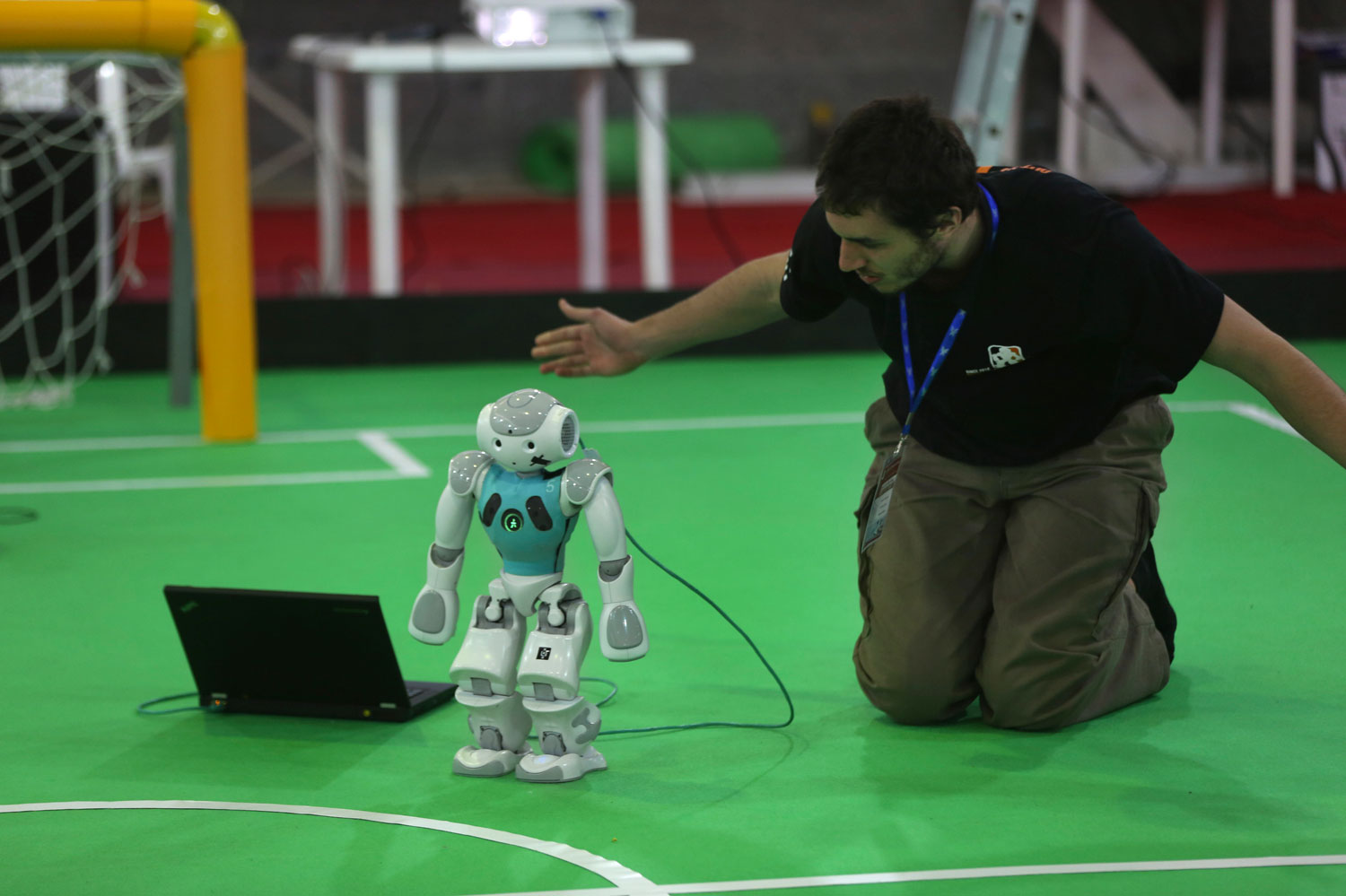 A participant from the Netherlands prepares his humanoid robot for a soccer match in the international robotics competition on April 10, 2014.