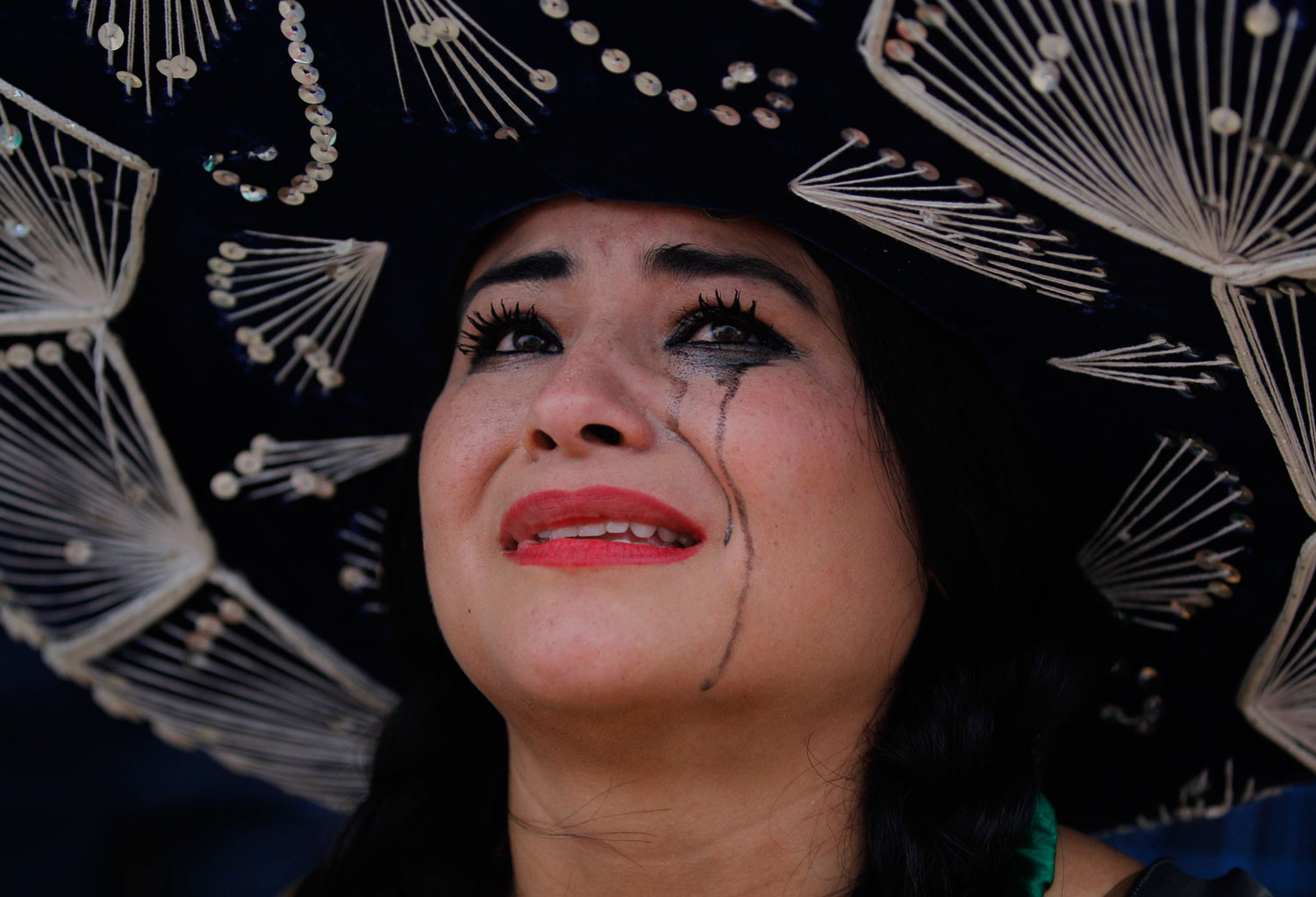 A Mexico soccer fan cries after her team was defeated, on Copacabana beach in Rio de Janeiro, Brazil on June 29, 2014.