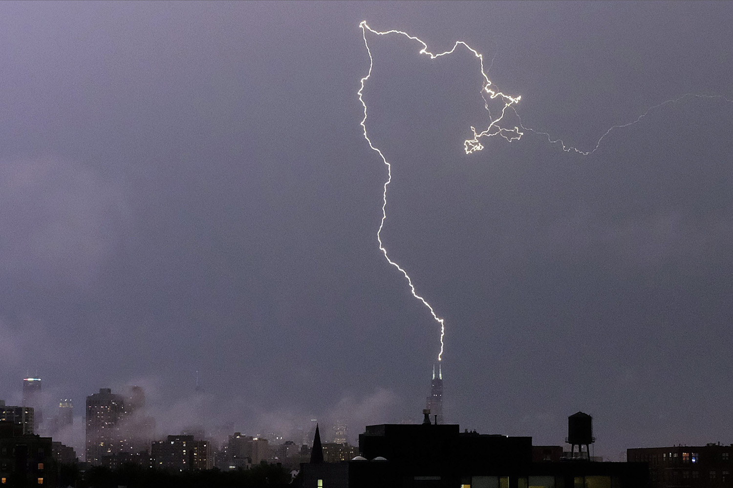 Jun. 30, 2014. A bolt of lightening strikes near the top of the Willis tower in downtown Chicago, as rain and high winds were moving into Illinois from Iowa.