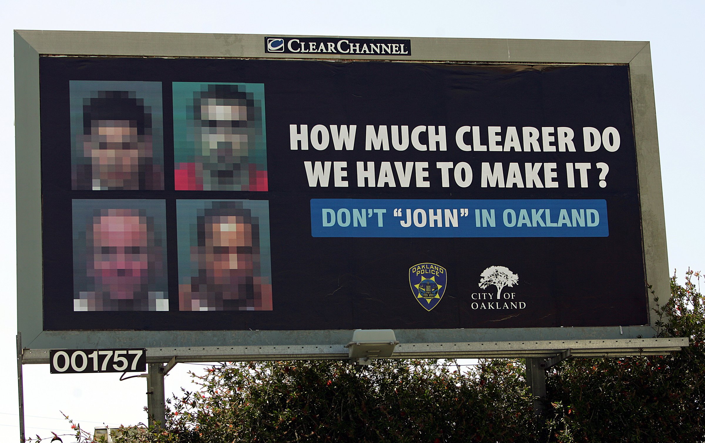 Images of four men convicted of soliciting prostitutes, intentionally blurred so they could not be recognized, are seen on a billboard on June 2, 2005, in Oakland, Calif.