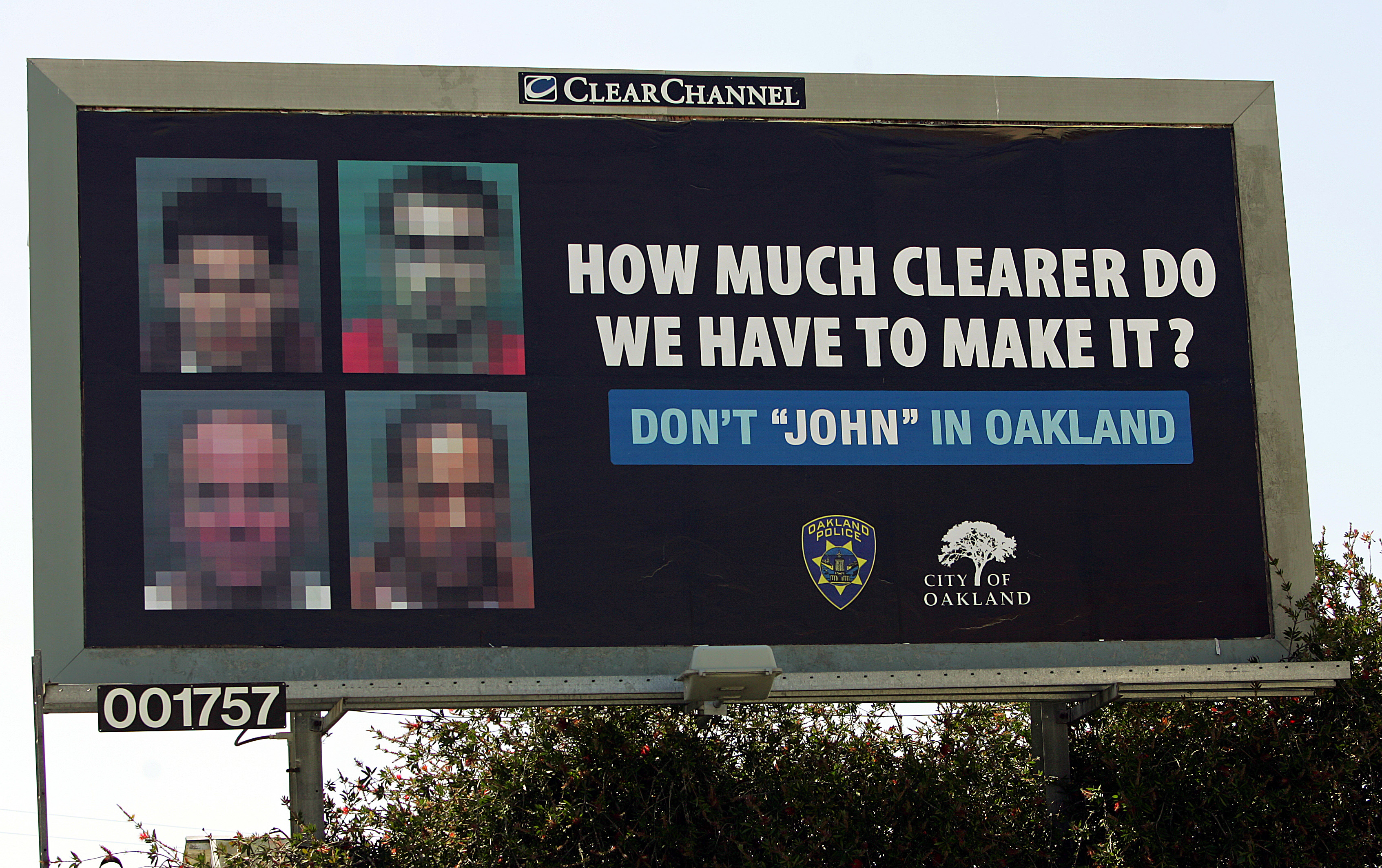 Images of four men convicted of soliciting prostitutes, intentionally blurred so they could not be recognized, are seen on a billboard on June 2, 2005, in Oakland, Calif. (Ben Margot—AP)