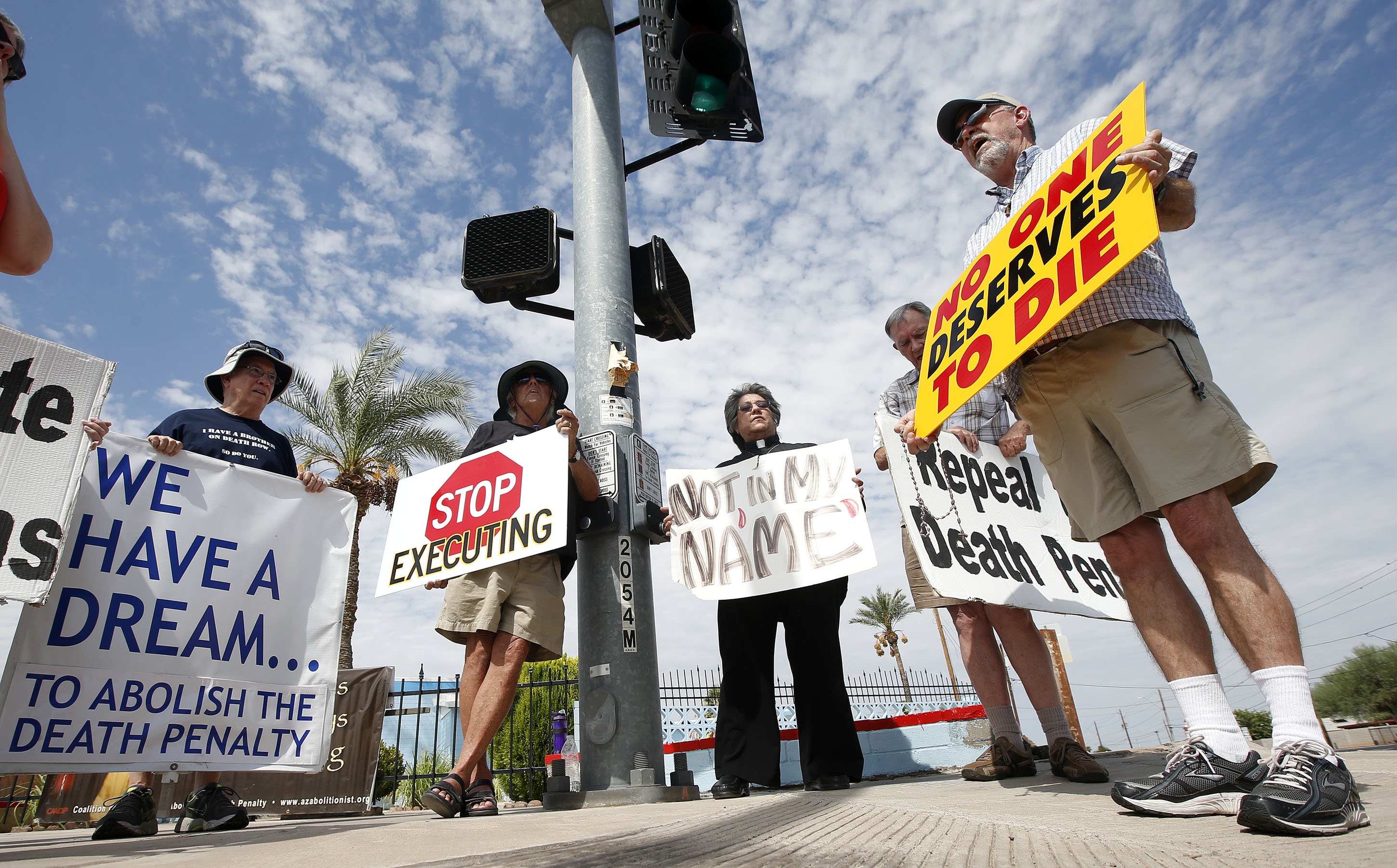 John Zemblidge, right, leads a group of about a dozen death-penalty opponents as they protest the execution of Joseph Wood at the state prison in Florence, Ariz., on July 23, 2014 (Associated Press)