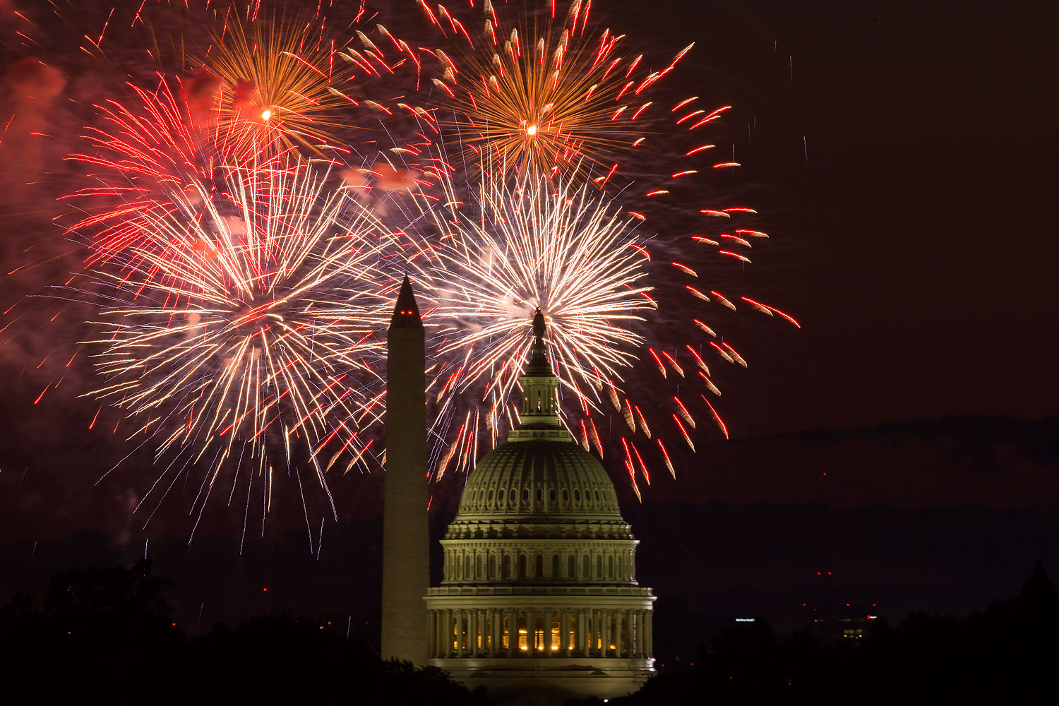 Fireworks illuminate the sky over the U.S. Capitol building and the Washington Monument during Fourth of July celebrations, on Friday, July 4, 2014, in Washington. (Evan Vucci—AP)