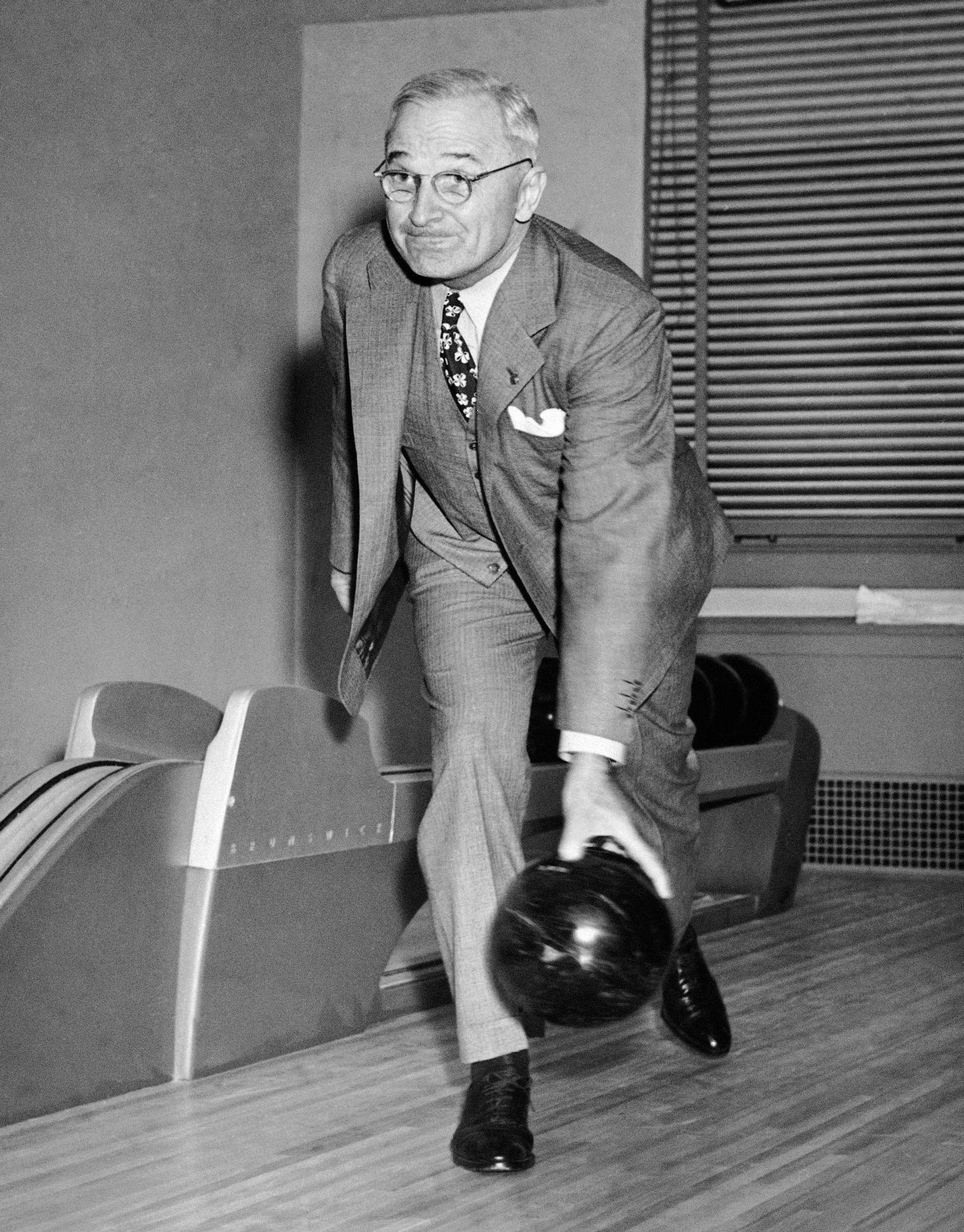 President Harry S. Truman rolls one down the alley at the formal opening of the White House bowling alley on April 19, 1947 in Washington. (AP)