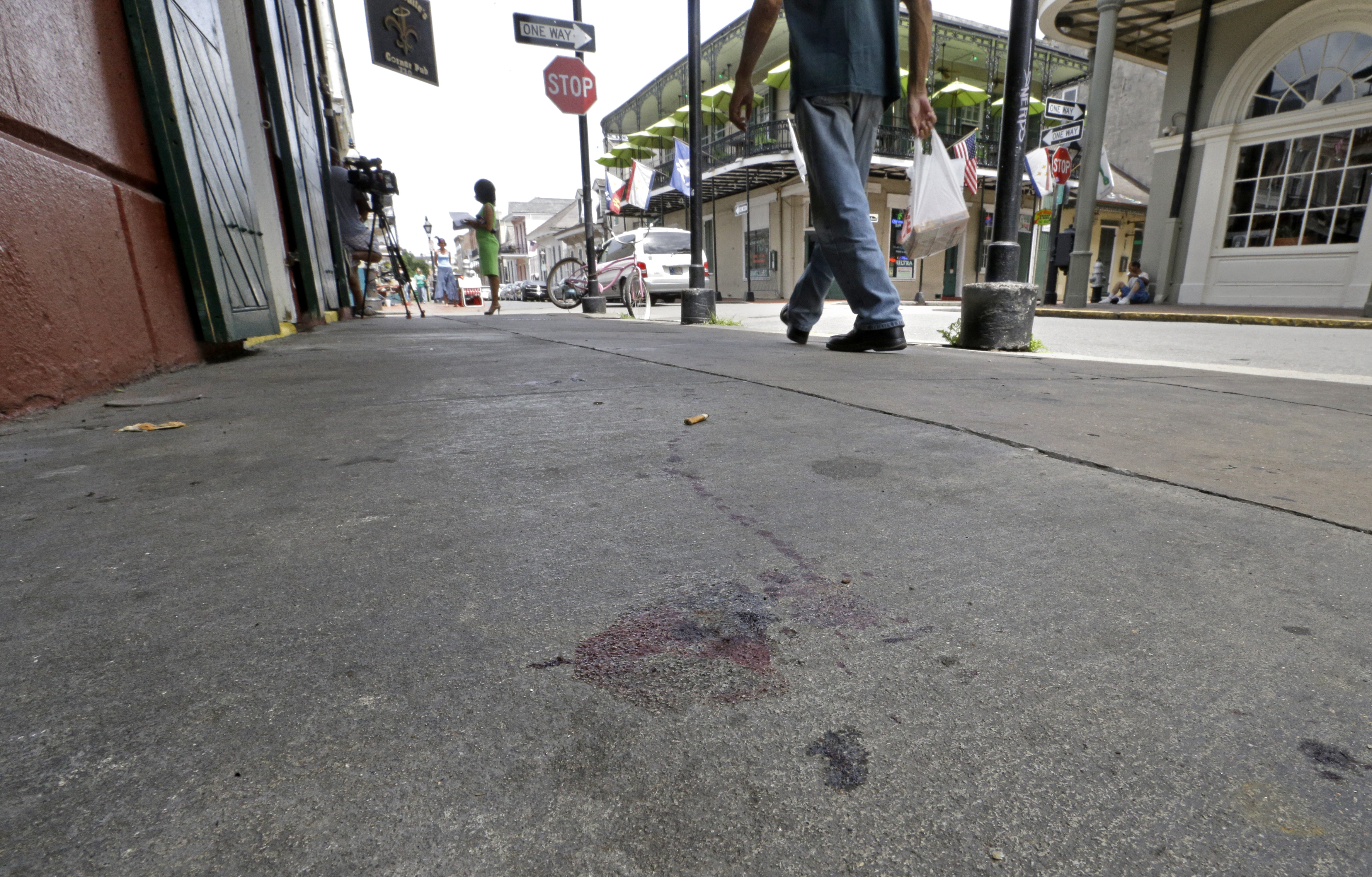 Blood stains are seen on the sidewalk at the scene of a shooting that happened early Sunday morning, June 29, 2014, on Bourbon Street in New Orleans. Nine people were injured, one seriously, according to New Orleans Police. (AP Photo/Gerald Herbert) (Gerald Herbert&mdash;AP)