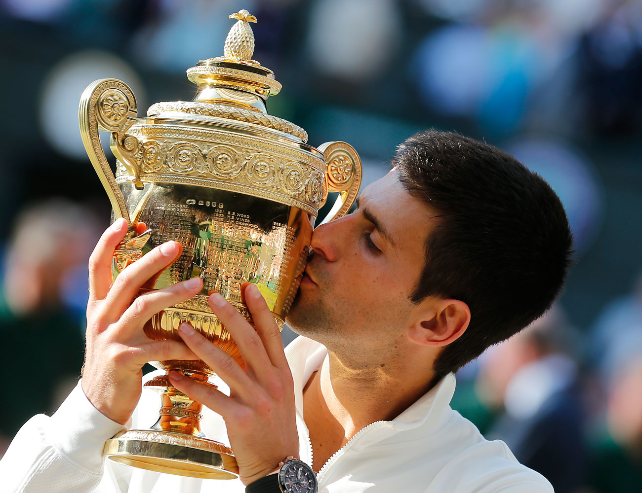 Novak Djokovic kisses the trophy after defeating Roger Federer in the men's singles final at the All England Lawn Tennis Championships in Wimbledon, London, on July 6, 2014