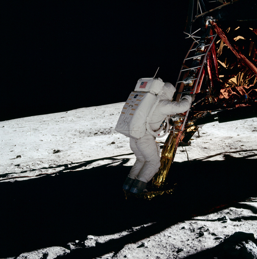 Buzz has both feet on the footpad. His communications antenna is visible.