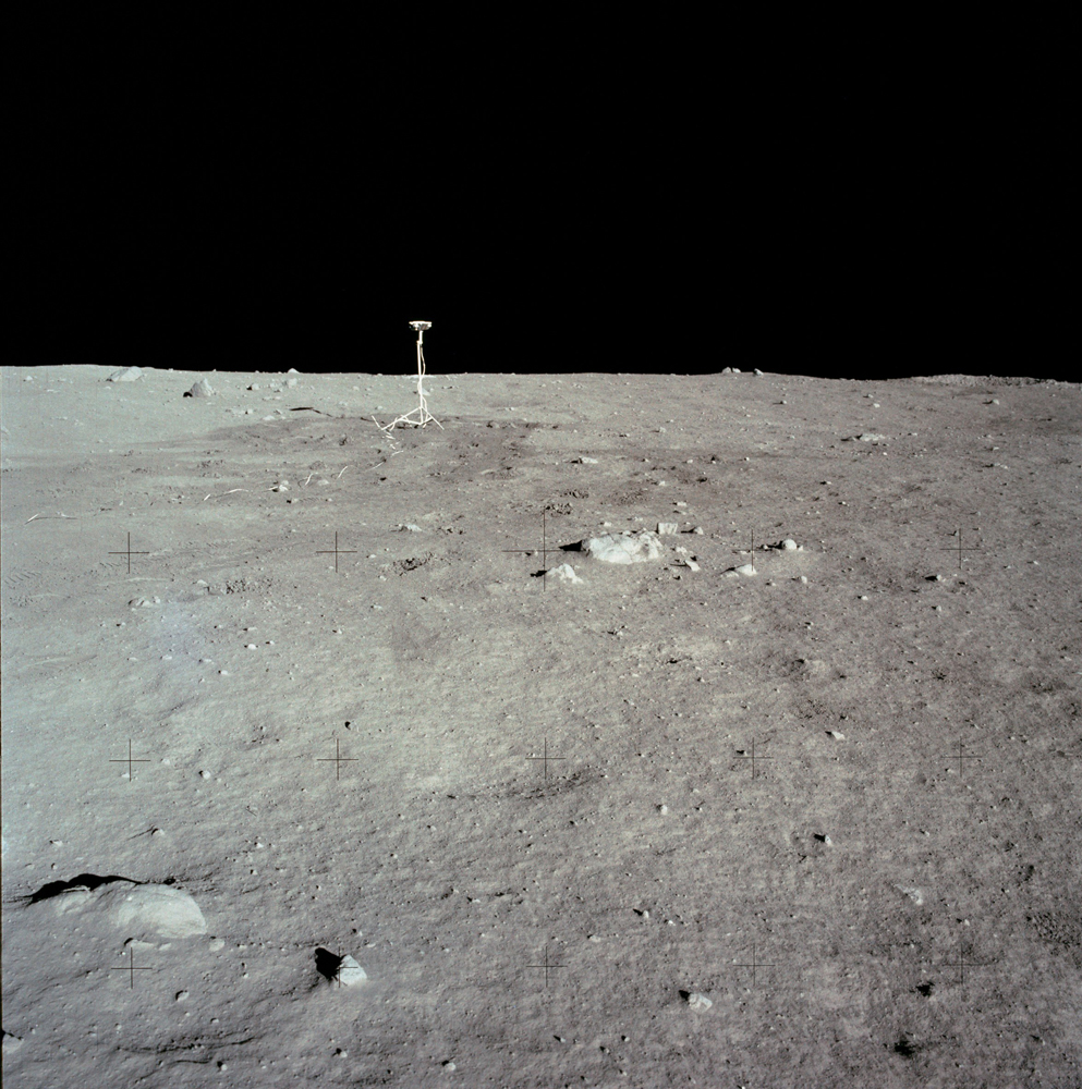 The lunar surface and horizon with the NASA TV camera visible just left of center.