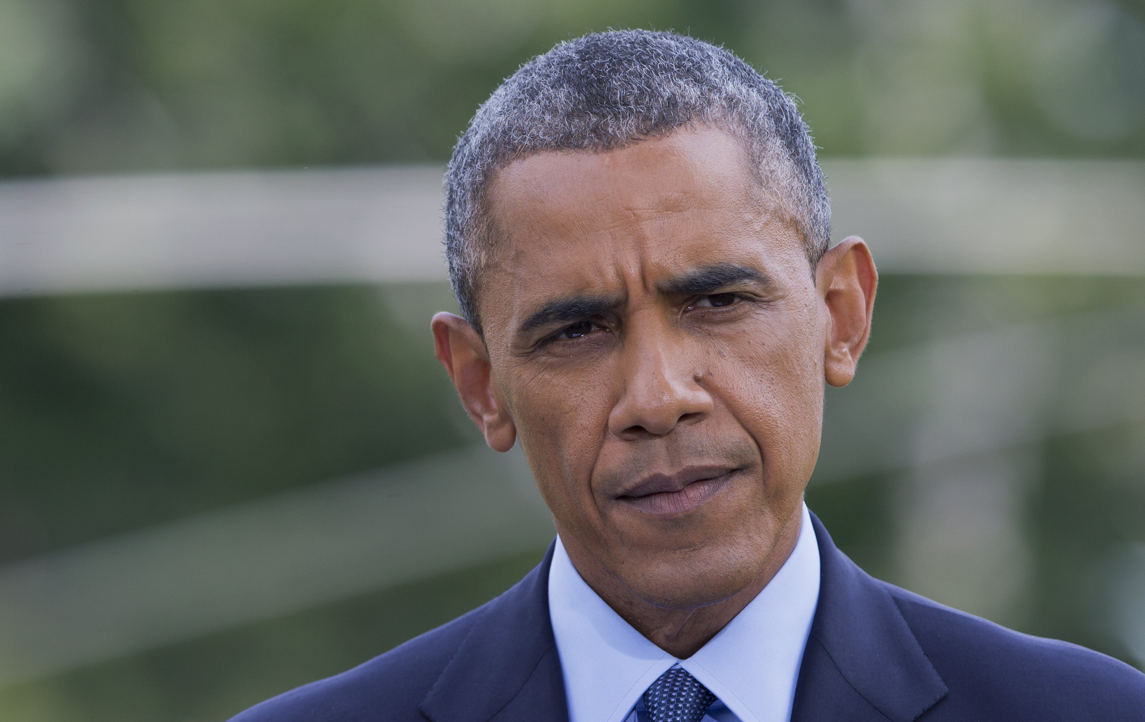 President Barack Obama pauses, as he announces new economic sanctions against key sectors of the Russian economy in the latest move by the U.S. to force Russian President Vladimir Putin to end his support for Ukrainian rebels, on the South Lawn of the White House in Washington on July 29, 2014. (Manuel Balce Ceneta—AP)