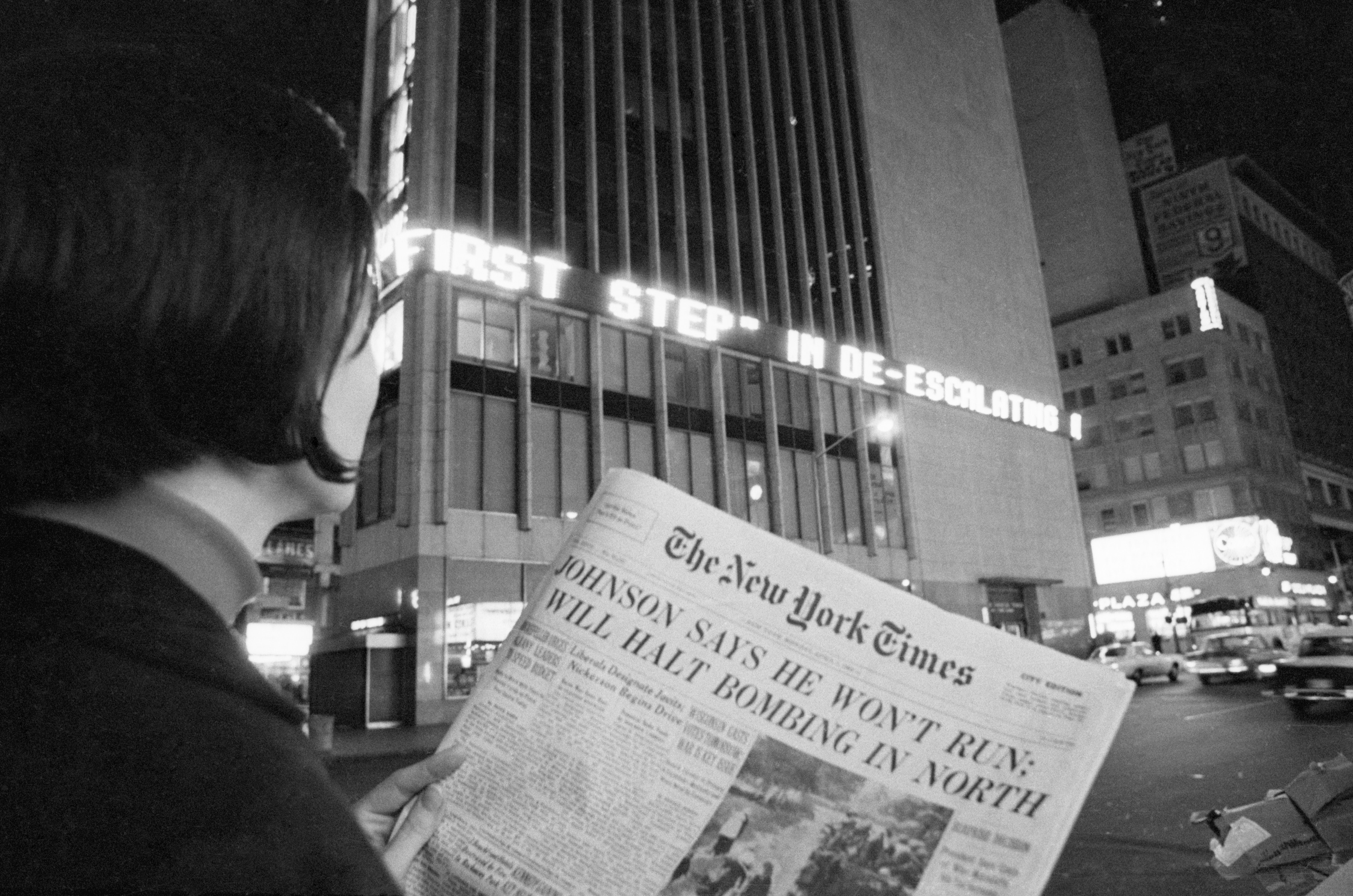 A woman reads the first page of the New York Times of Aril 1, 1968, when the headlines declared : "Johnson Says He Won't Run; Will Halt Bombing in North". This referred to President Johnson's refusal to accept or seek renomination. (Bettmann/CORBIS)
