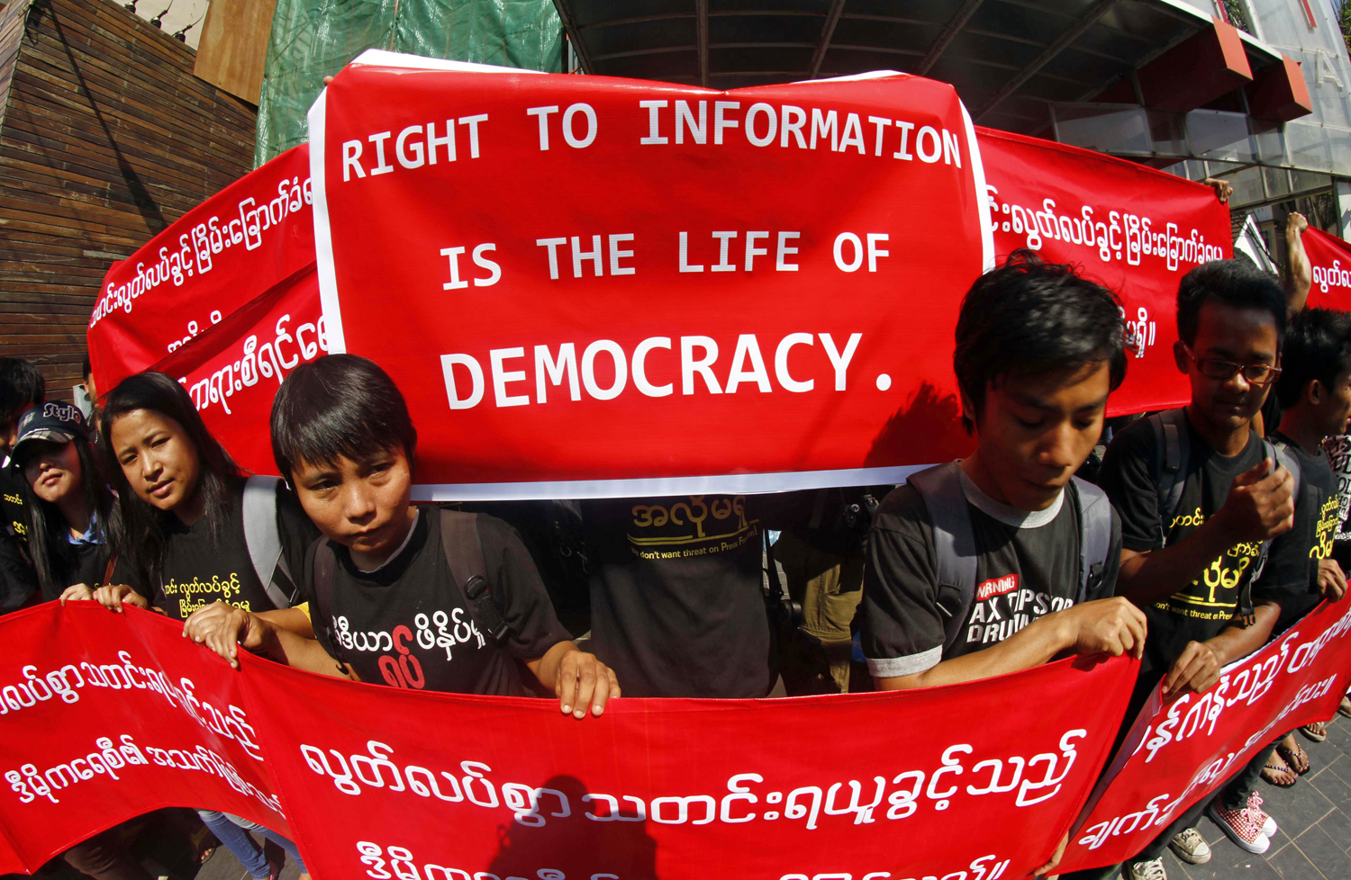Burmese journalists hold banners as they protest for press freedom outside the office of the Daily Eleven newspaper in Rangoon on Jan. 7, 2014. (Khin Maung Win—AP)