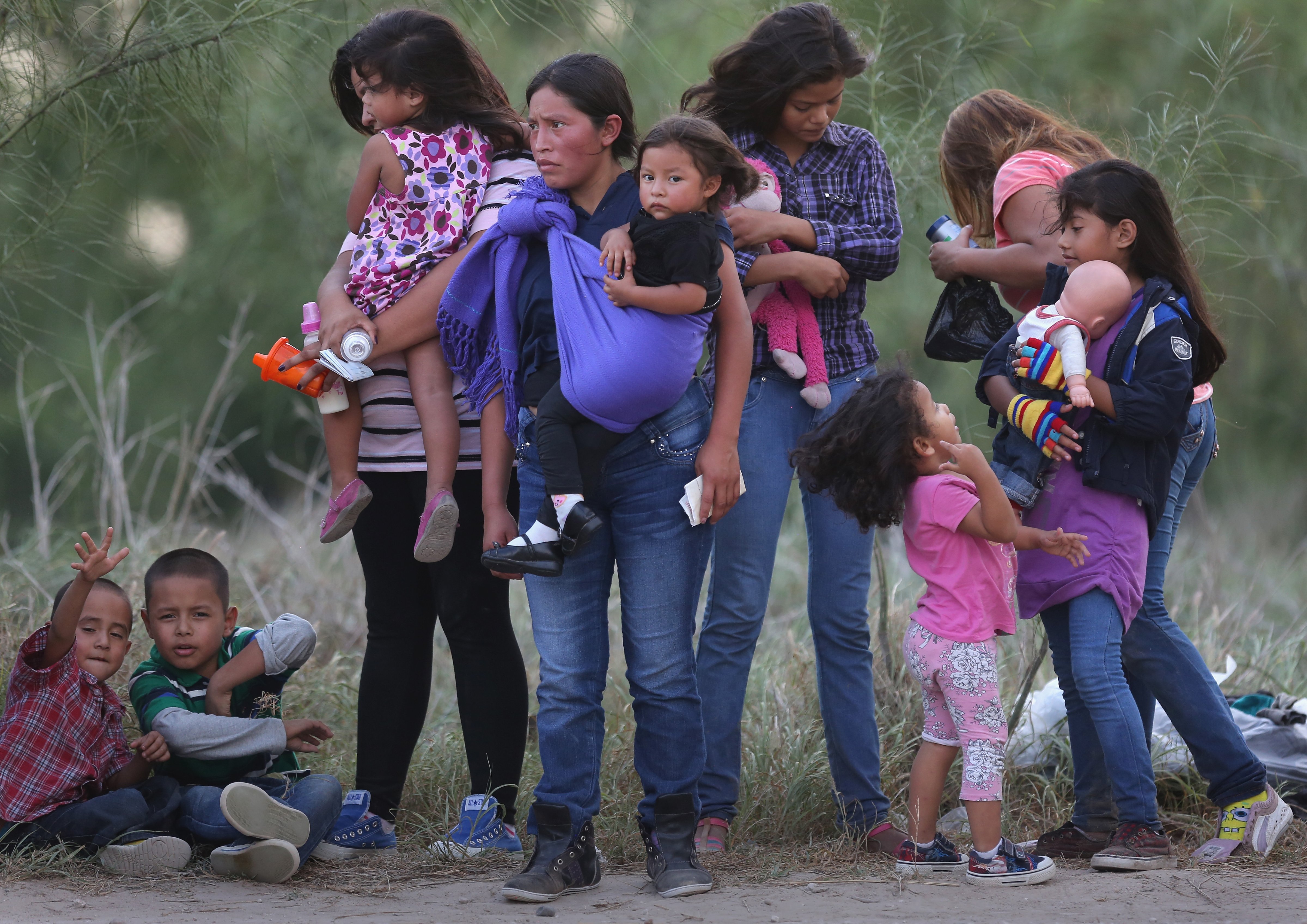 Central American immigrants await transportation to a U.S. Border Patrol processing center on July 24, 2014 near Mission, Texas. (John Moore—Getty Images)