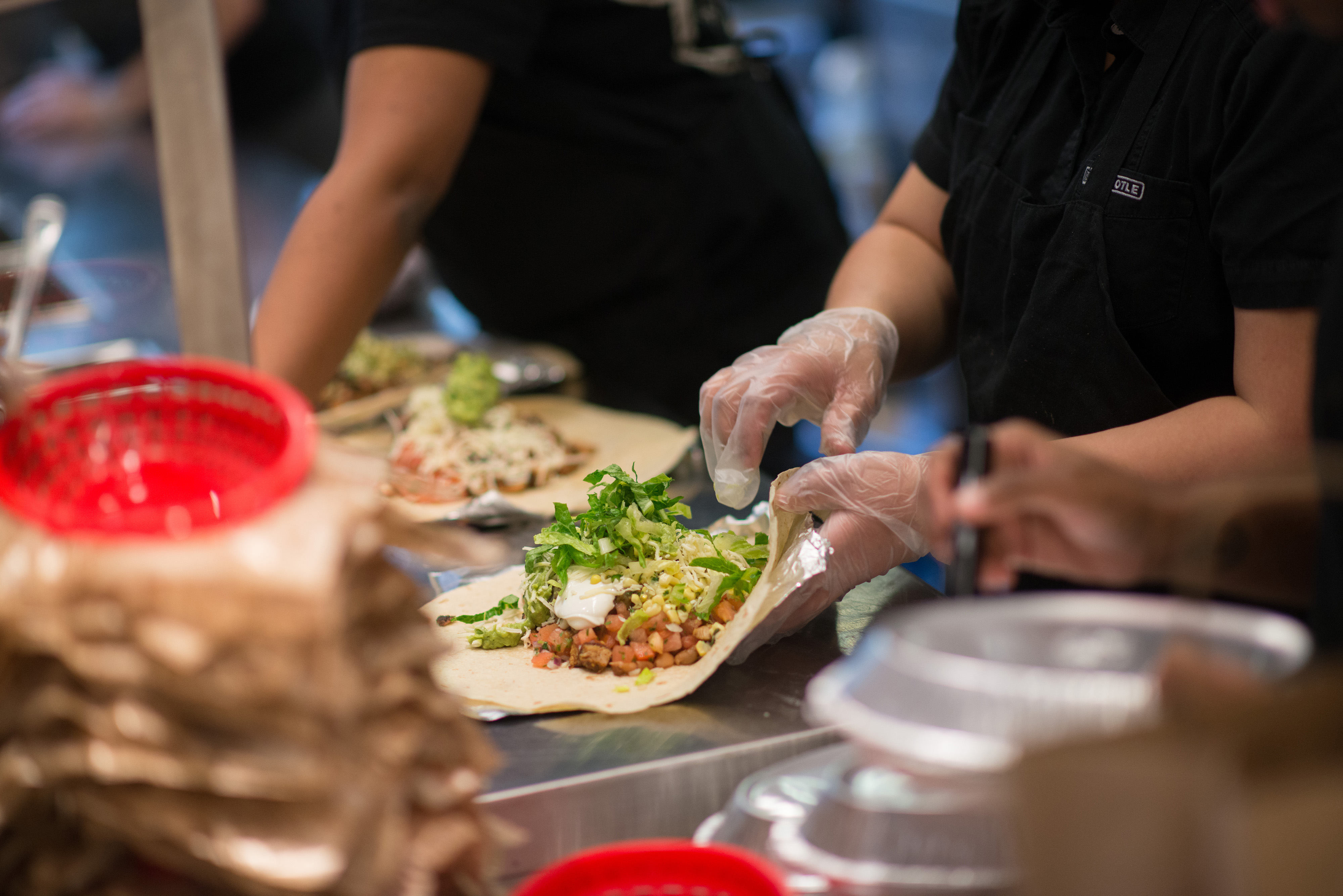 Employees prepare lunch orders at a Chipotle Mexican Grill restaurant at Madison Square Park in New York, U.S., on Wednesday, Jan. 29, 2014. (Bloomberg&mdash;Bloomberg via Getty Images)