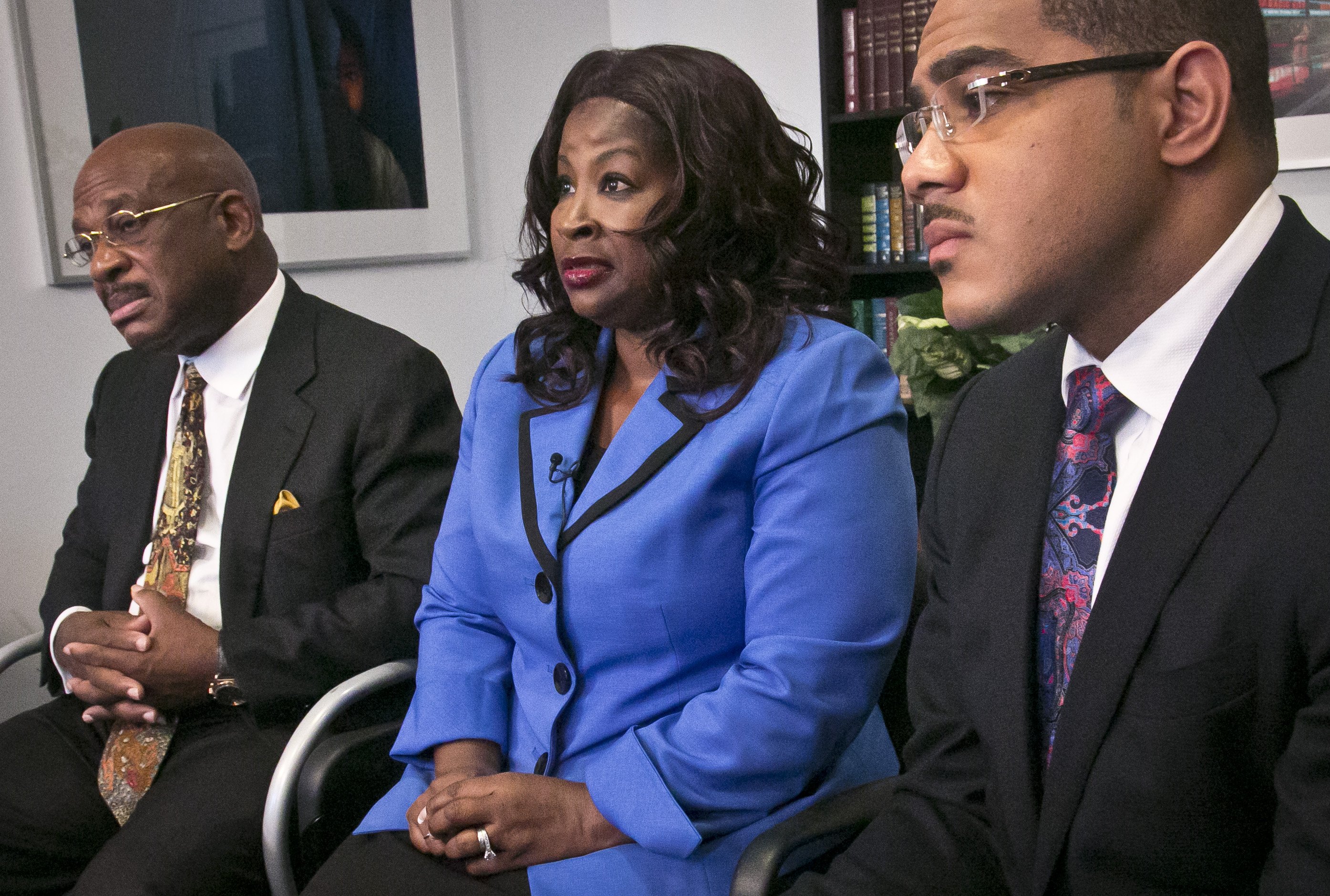 Cynthia Robinson with her attorneys Willie Gary (left) and Christopher Chestnut (right) as she speaks during an interview on July 21, 2014 in New York City. (Bebeto Matthews—AP)