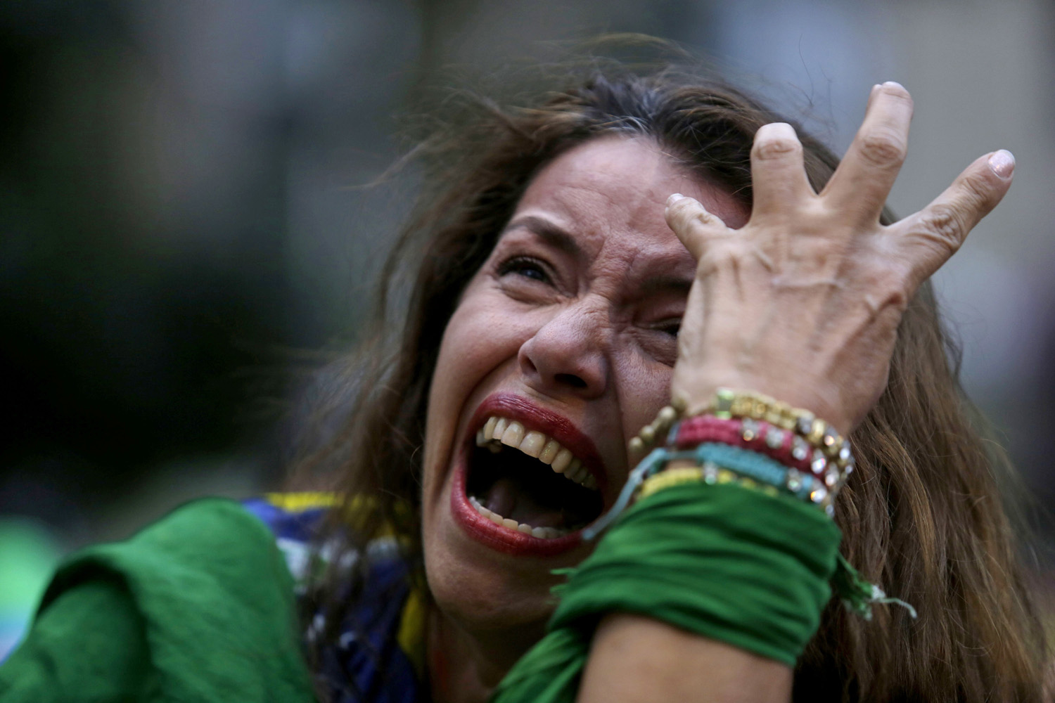 A Brazilian soccer fan cries as Germany scores against her team at a semifinal World Cup match as she watches the game on a live telecast in Belo Horizonte, Brazil on July 8, 2014.