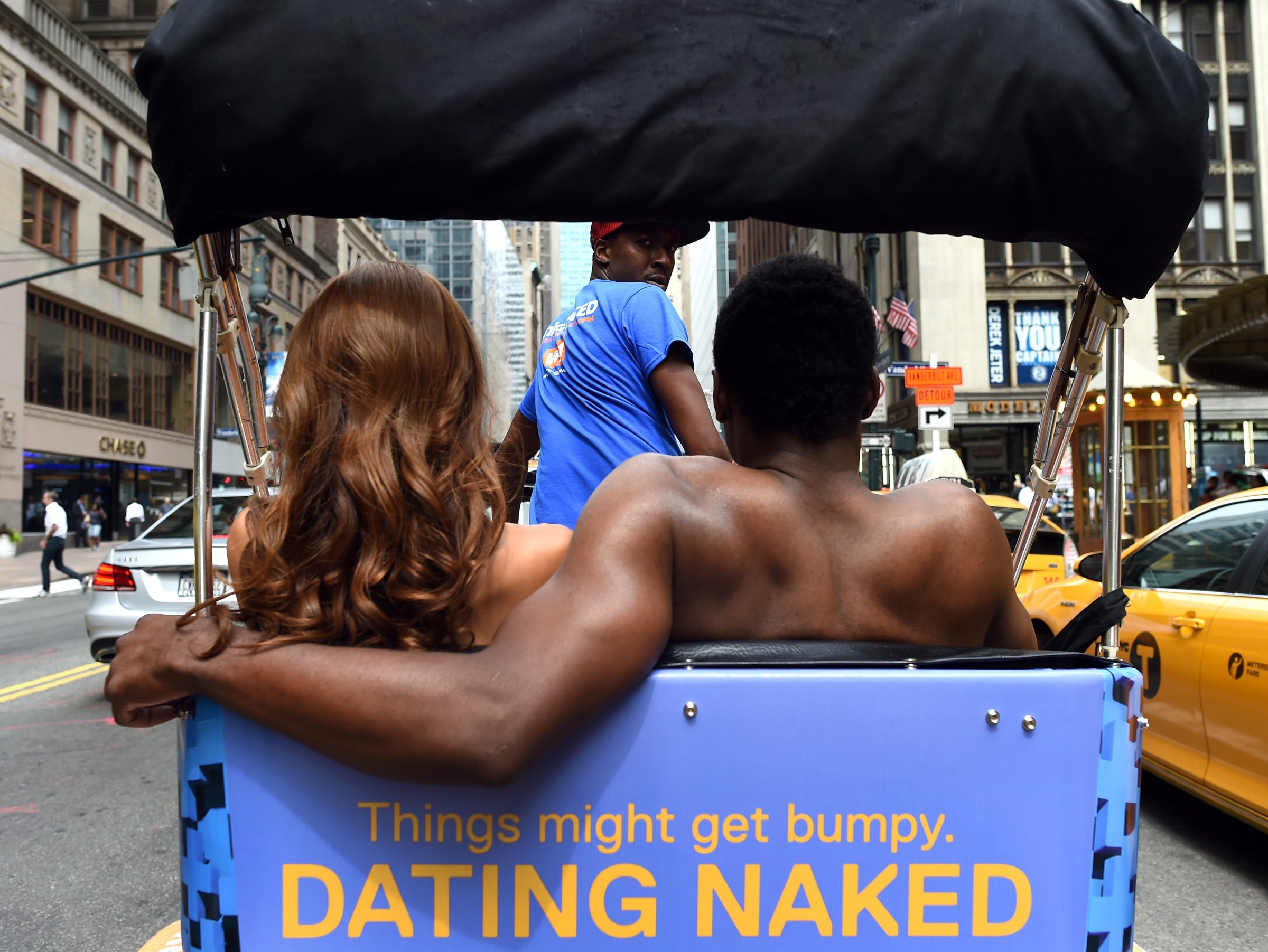 Kelly Keodara and Yarc Lewinson ride around Grand Central Station in New York City on July 16, 2014 in a pedicab to promote a new VH1 series "Dating Naked".