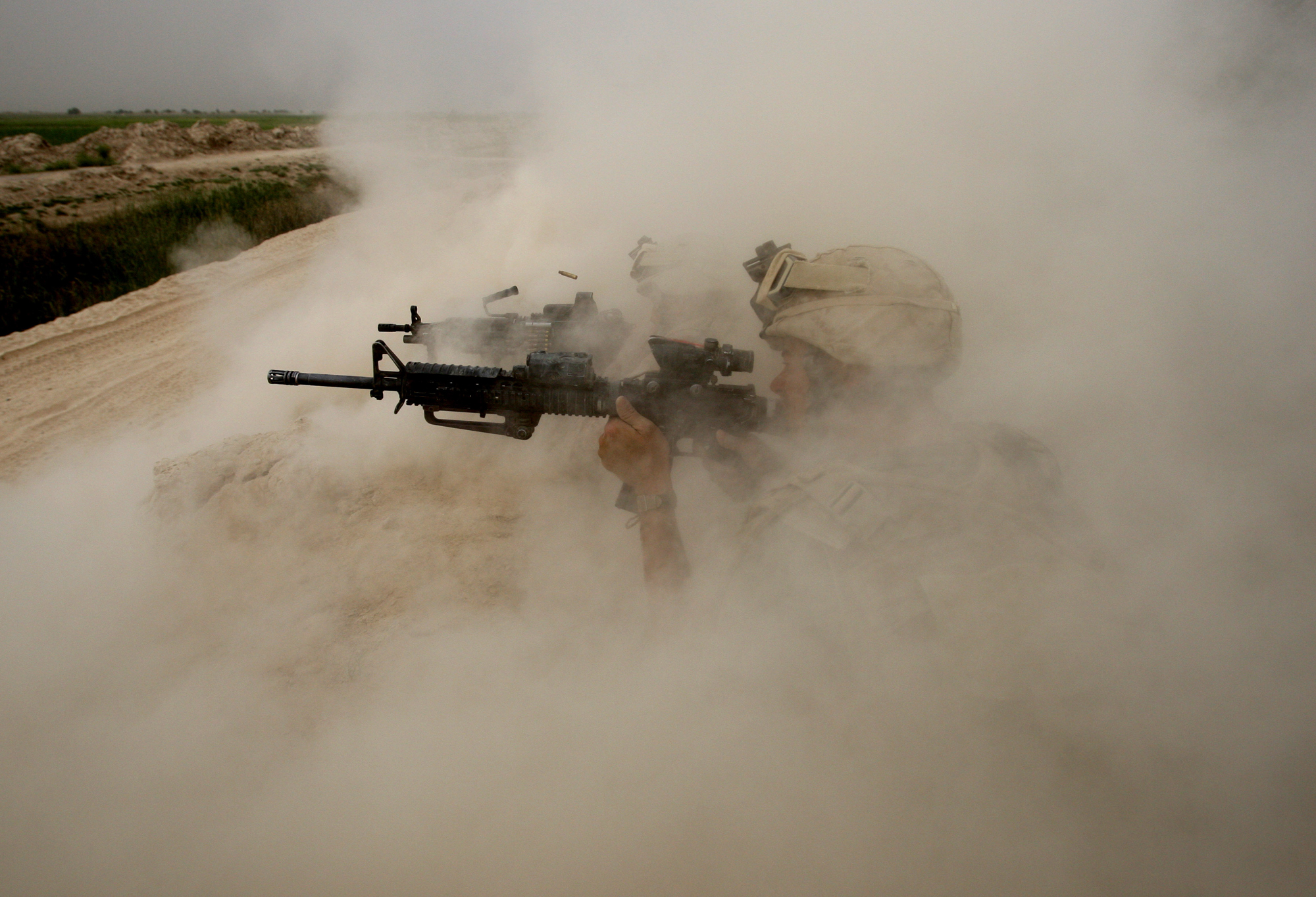 U.S. Marines, from the 24th Marine Expeditionary Unit, return fire on Taliban positions near the town of Garmser in Helmand Province of Afghanistan, May 2, 2008.