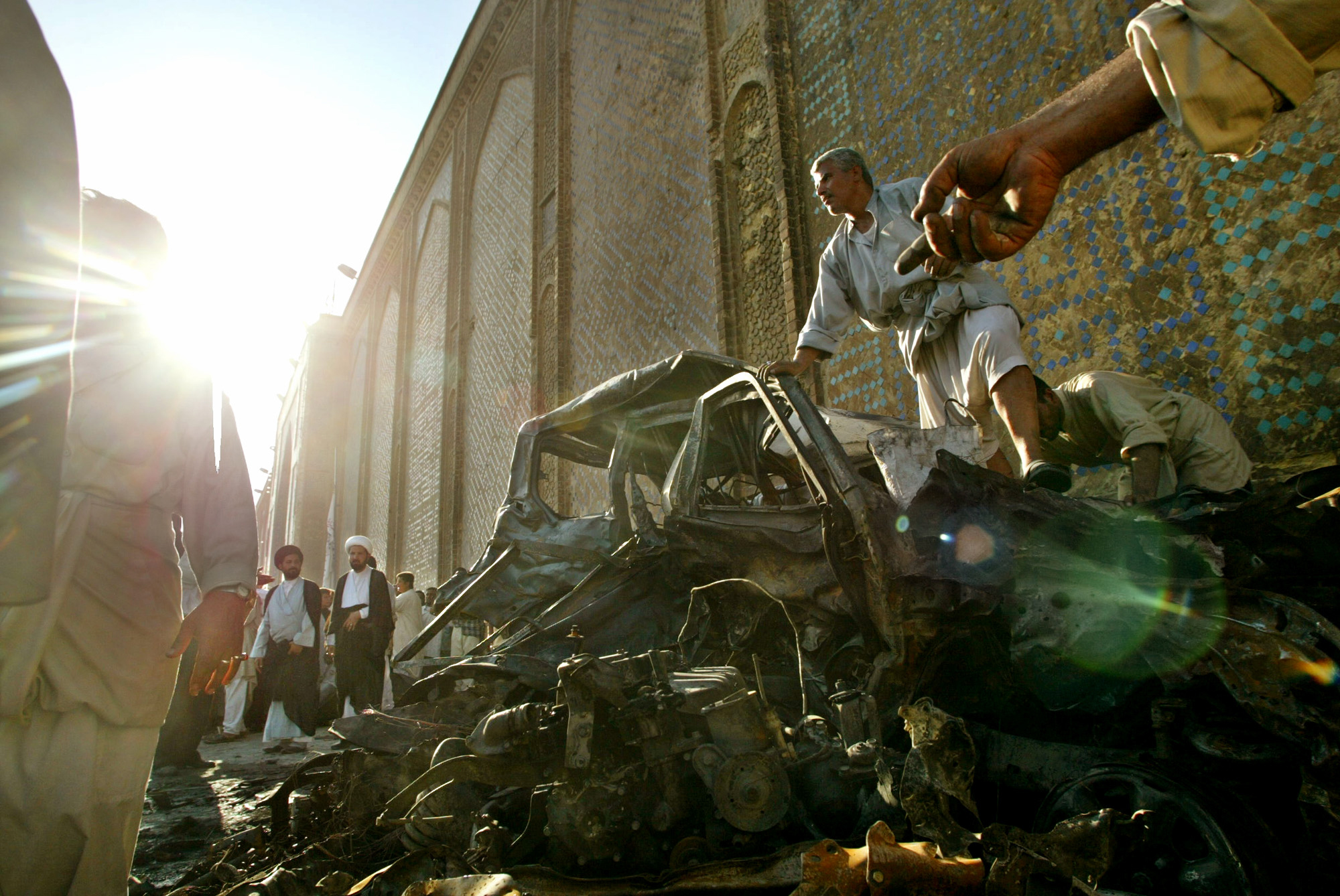 Iraqis dig through the rubble left after a car bomb exploded next to the Imam Ali shrine in Najaf, Iraq killing at least 75 and wounding 140 others, Aug. 29, 2003.