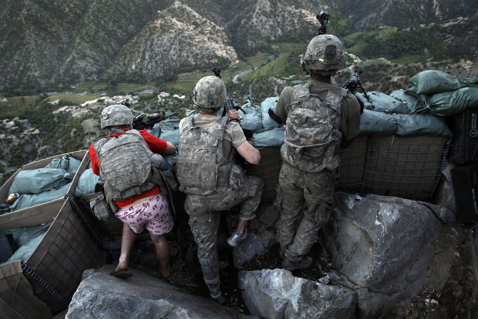 Soldiers from the U.S. Army First Battalion, 26th Infantry take defensive positions at firebase Restrepo after receiving fire from Taliban positions in the Korengal Valley of Afghanistan's Kunar Province on May 11, 2009. Photo was awarded 2nd prize in the  People in the News Singles category in the 2010 World Press Photo contest.