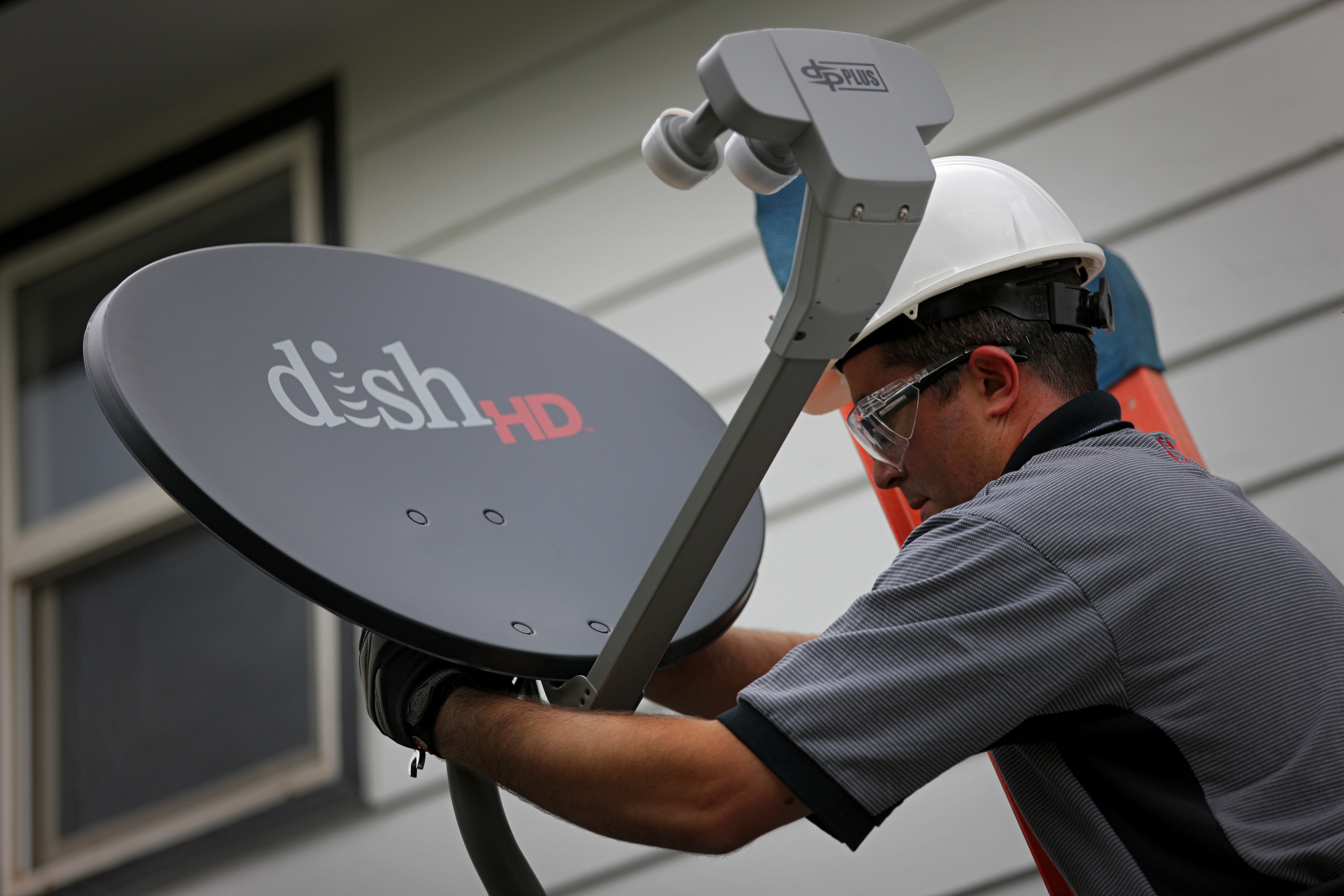 A satellite television system is installed at a residence in Denver, Colorado, on Aug. 6, 2013. (Bloomberg—Bloomberg via Getty Images)