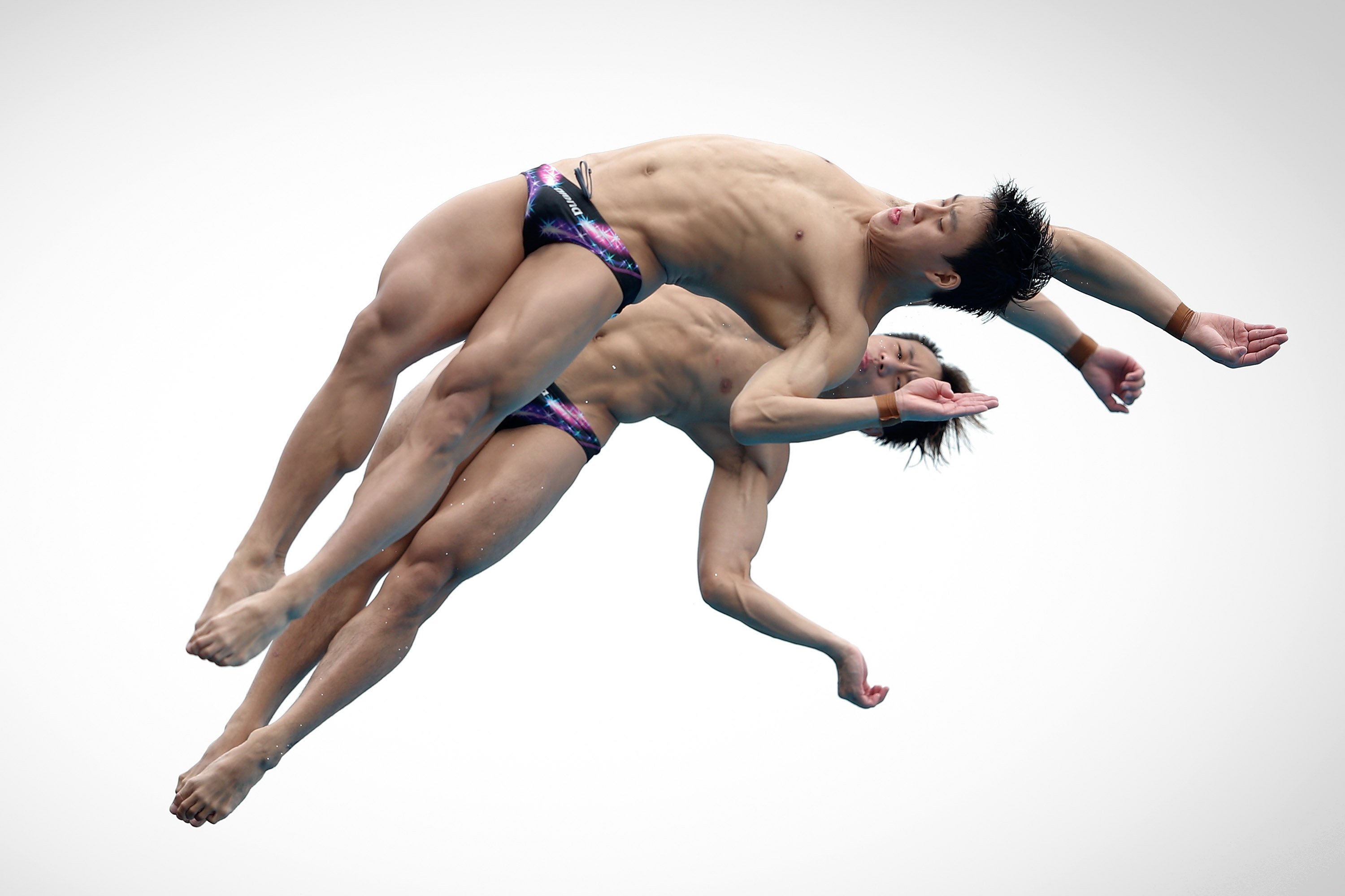 Lin Yue and Cao Yuan of China compete in the men's 10M Synchro Springboard Preliminary on day two of the 19th FINA Diving World Cup at the Oriental Sports Center in Shanghai on July 16, 2014.