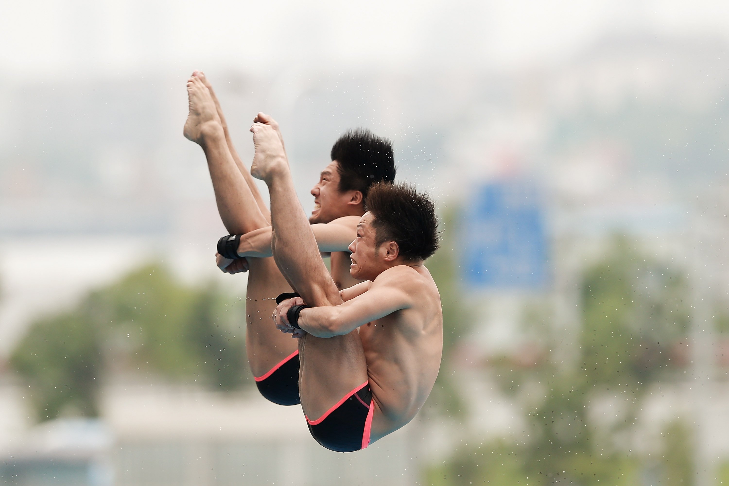 Yu Okamoto and Kazuki Murakami of Japan compete in the men's 10M Synchro Springboard Preliminary on day two of the 19th FINA Diving World Cup at the Oriental Sports Center in Shanghai on July 16, 2014.