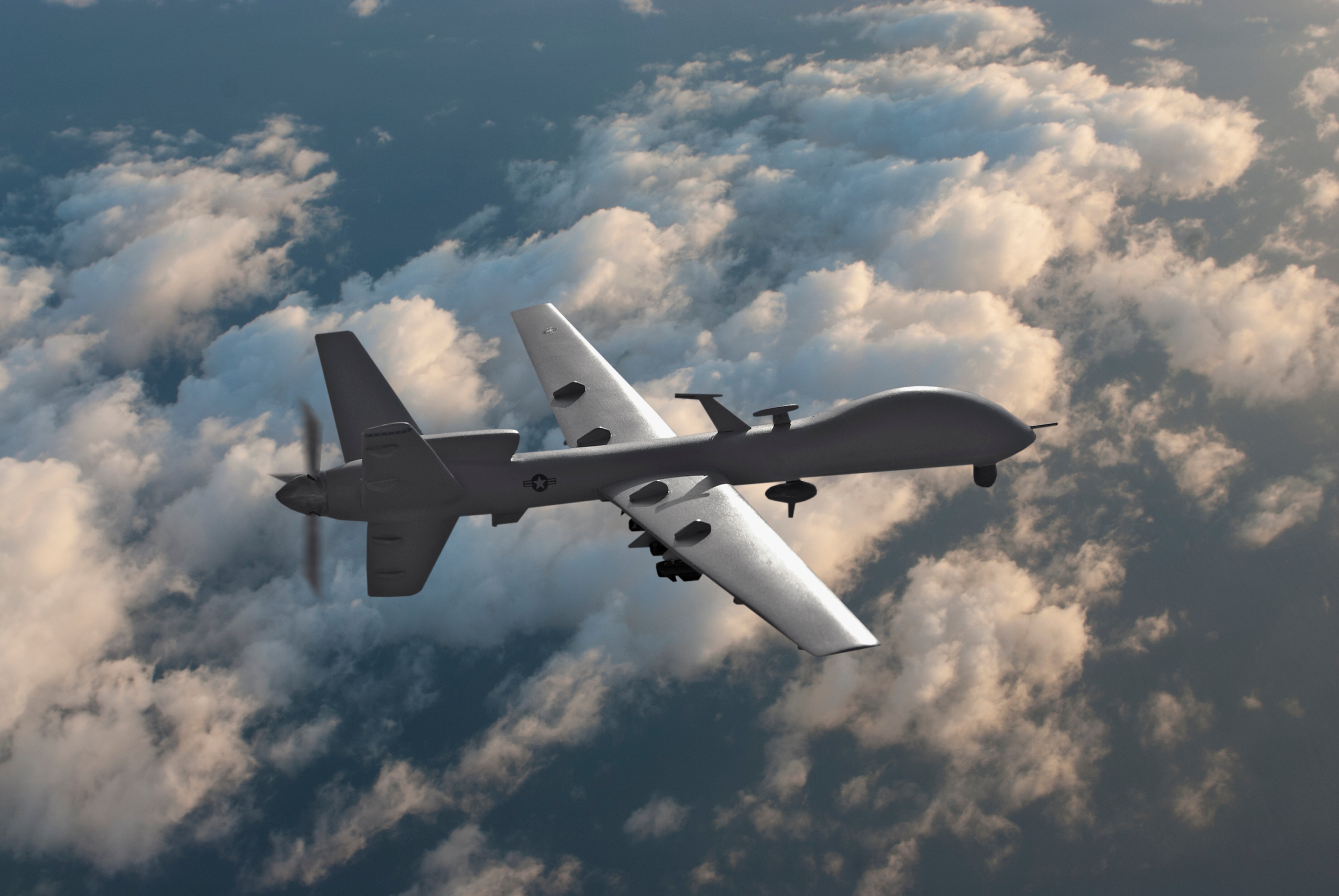 Military drone flying over the clouds. (Erik Simonsen—Getty Images)