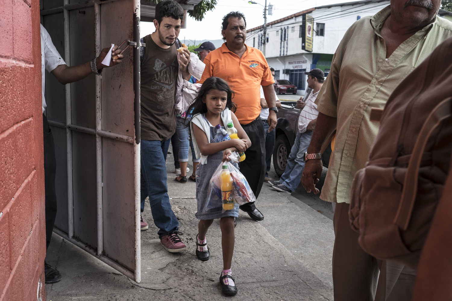 A young girl walks outside the return center for deported migrants in San Pedro Sula. Honduras. July 17, 2014.