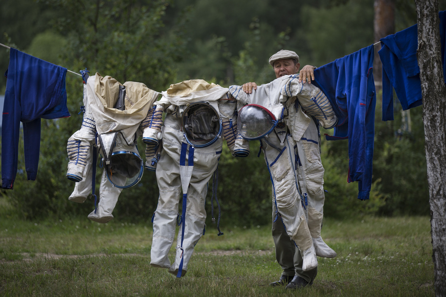 Jul. 2, 2014. An employe of Russian Space Training Center hangs out to dry space suits of Russian cosmonaut Anatoly Ivanishin, NASA's U.S. flight engineer Kathleen Rubins, and Japanese space agency's flight engineer Takuya Onishi, right, after their undergoing  training near in Noginsk, 60 km (38 miles) east of Moscow, Russia.