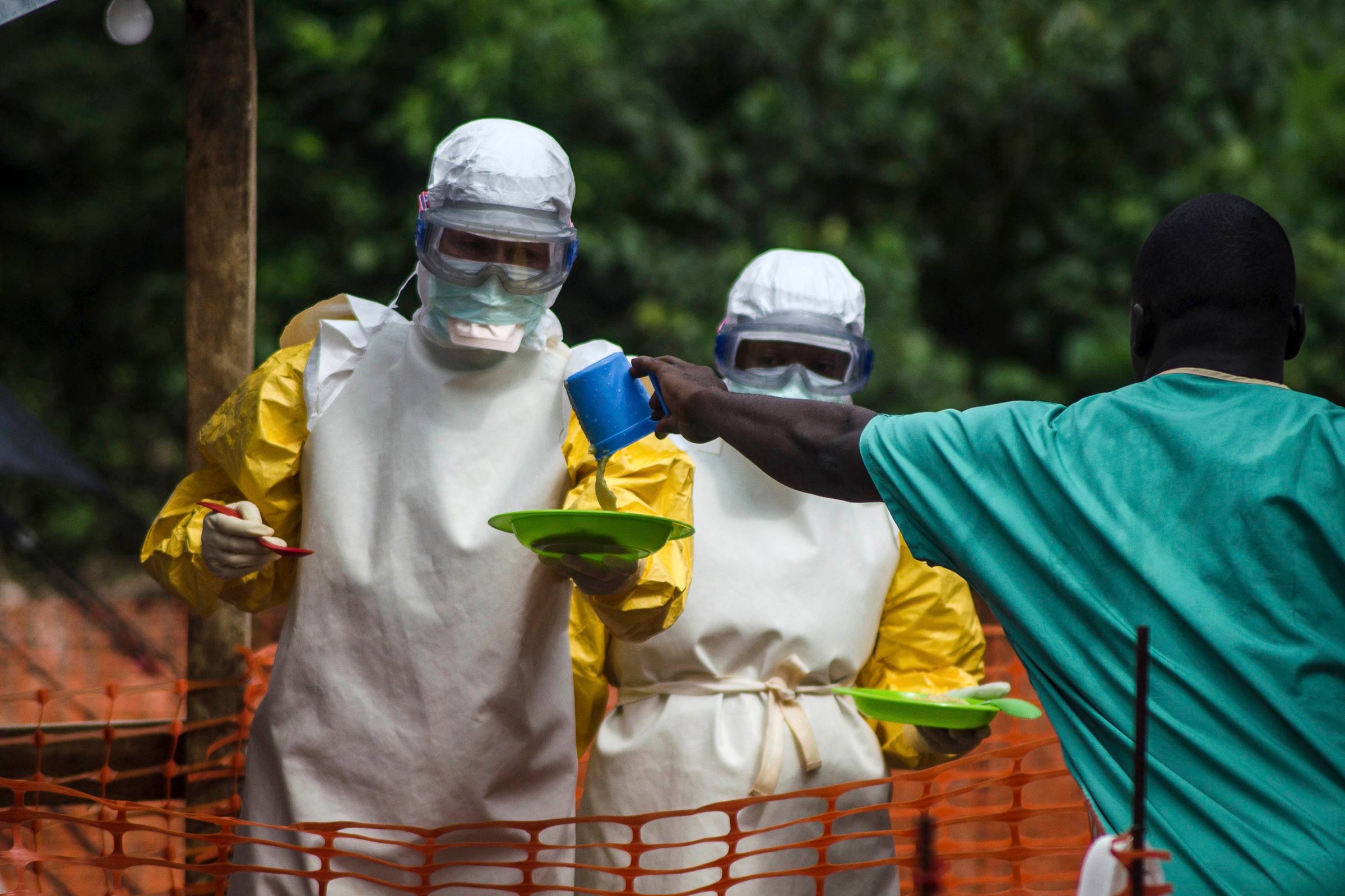 Medical staff working with Medecins sans Frontieres (MSF) prepare to bring food to patients kept in an isolation area at the MSF Ebola treatment centre in Kailahun, Sierra Leone on July 20, 2014.