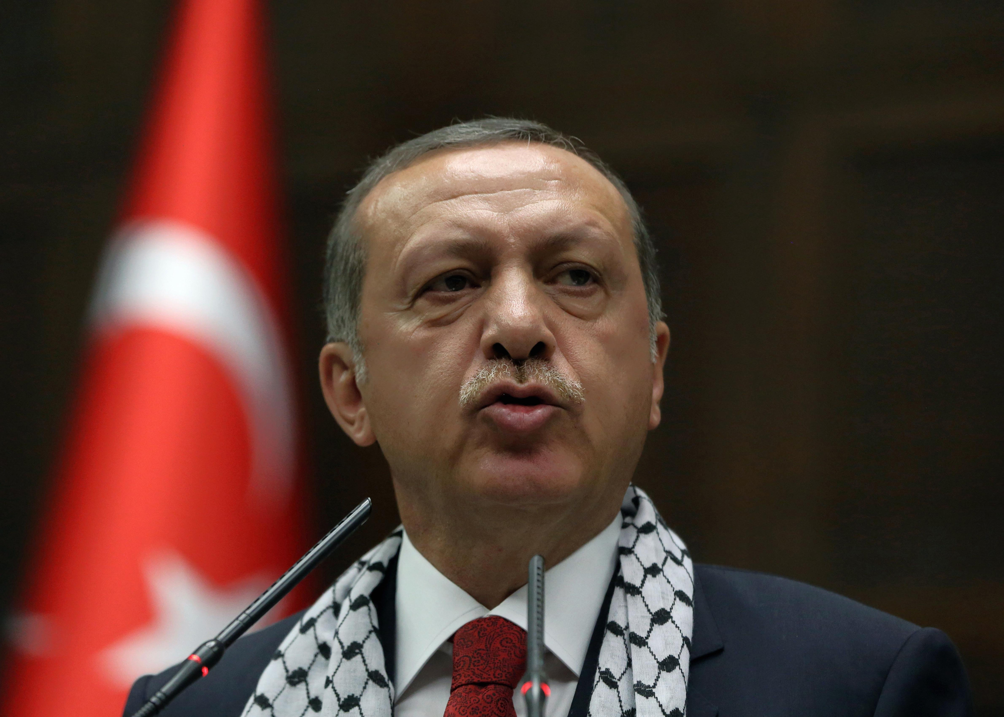 Turkish Prime Minister Recep Tayyip Erdogan addresses his supporters at parliament wearing a Palestinian keffiyeh, in Ankara, July 22, 2014. (Burhan Ozbilici—AP)