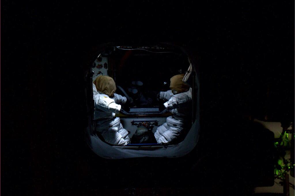 Freaky to float past the airlock at night. #Spacesuits silently wait for us to join them.