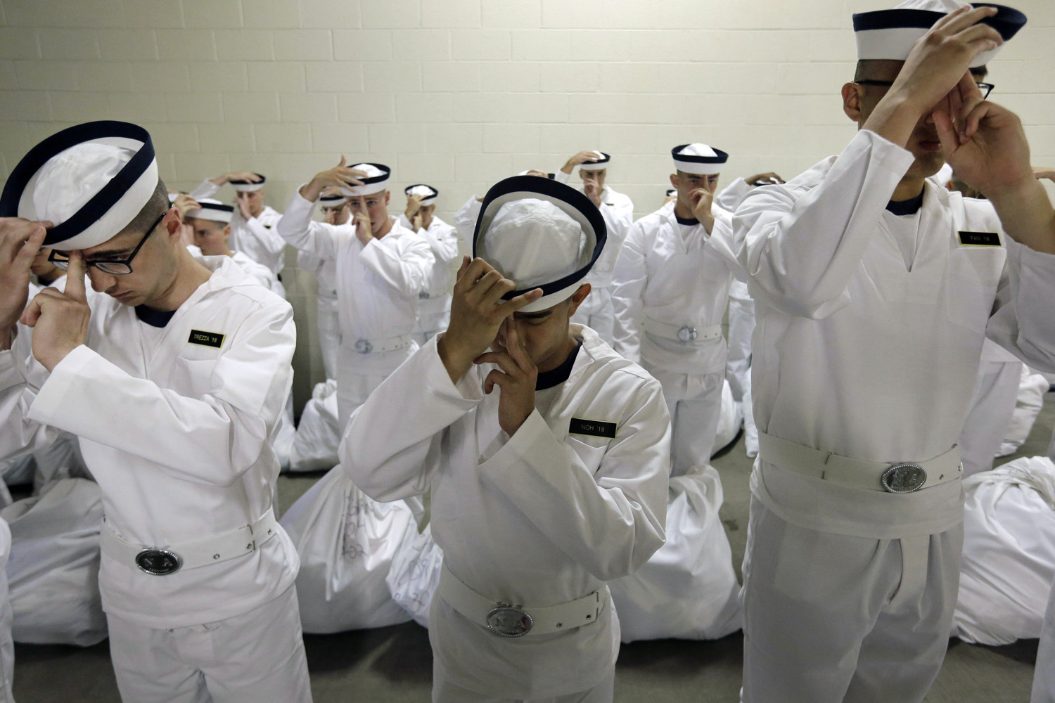 Jul. 1, 2014. Prospective plebes learn how to properly wear their covers during Induction Day at the U.S. Naval Academy in Annapolis, Md.