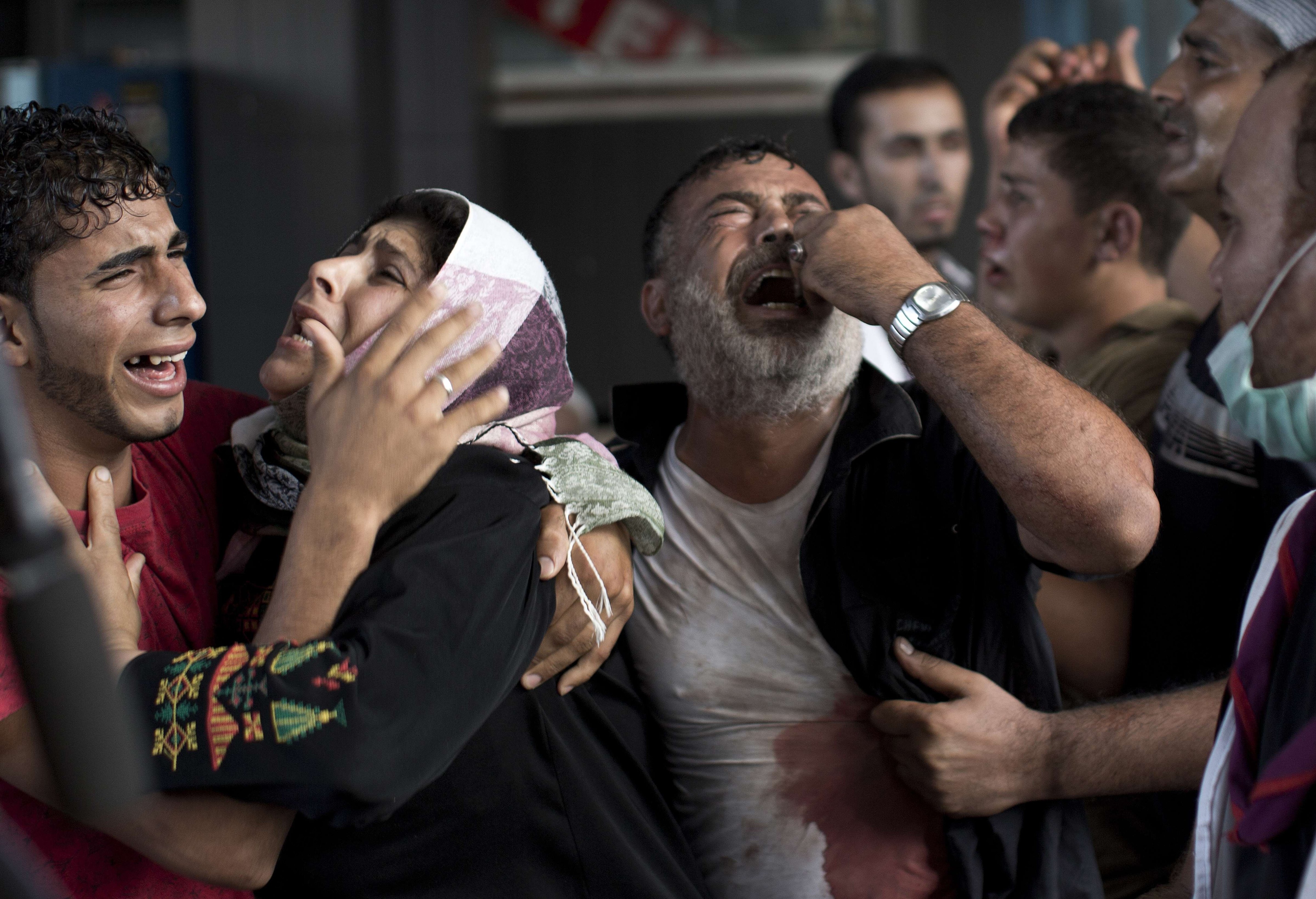 Palestinian mourners cry at al-Shifa Hospital in Gaza City after an explosion killed at least seven children in a public playground in the beachfront Shati refugee camp on July 28, 2014 (Mahmud Hams—AFP/Getty Images)